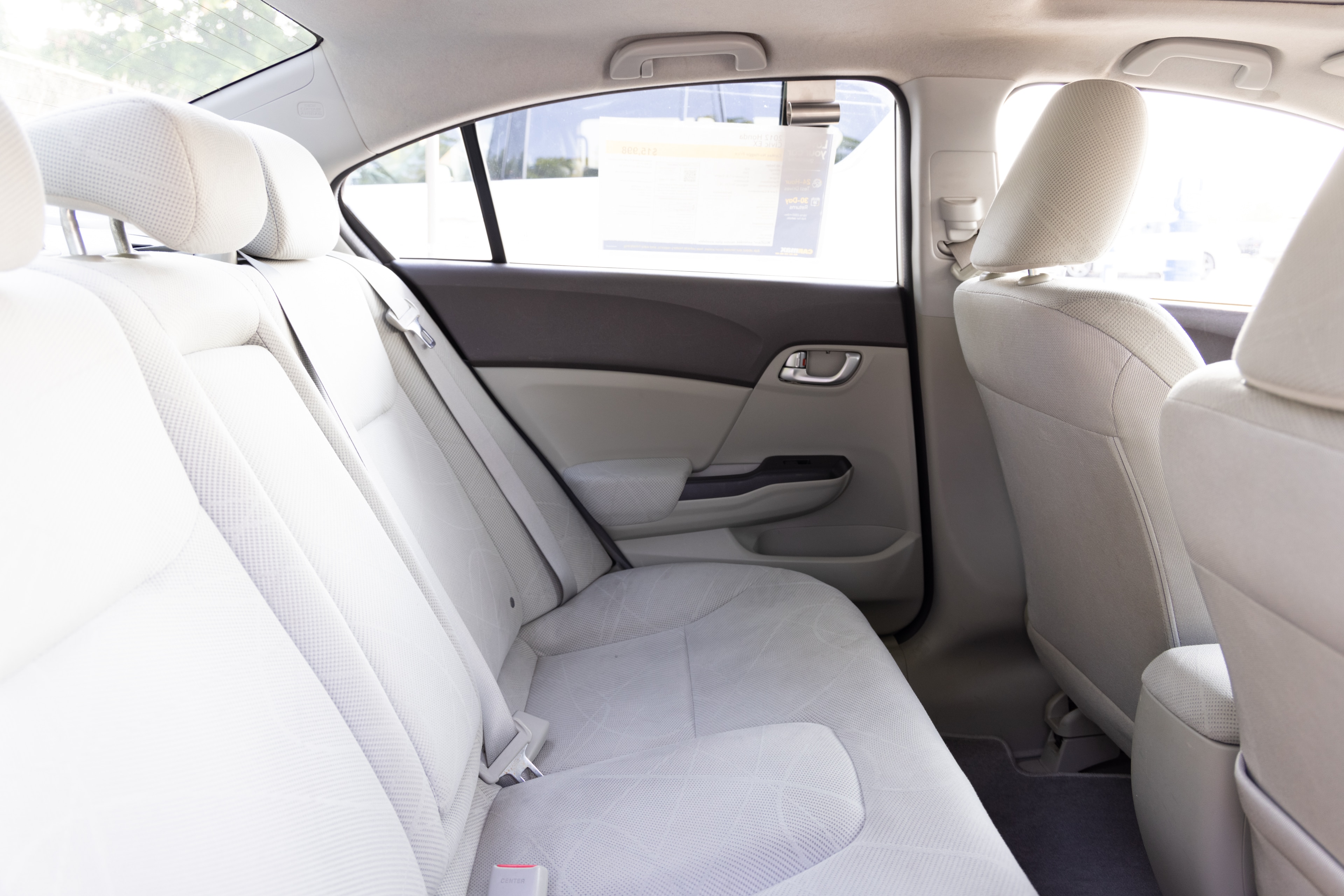 A series of second-row backseat photos is shown including one seating a baby seat and one seating a 6'1" mannequin.