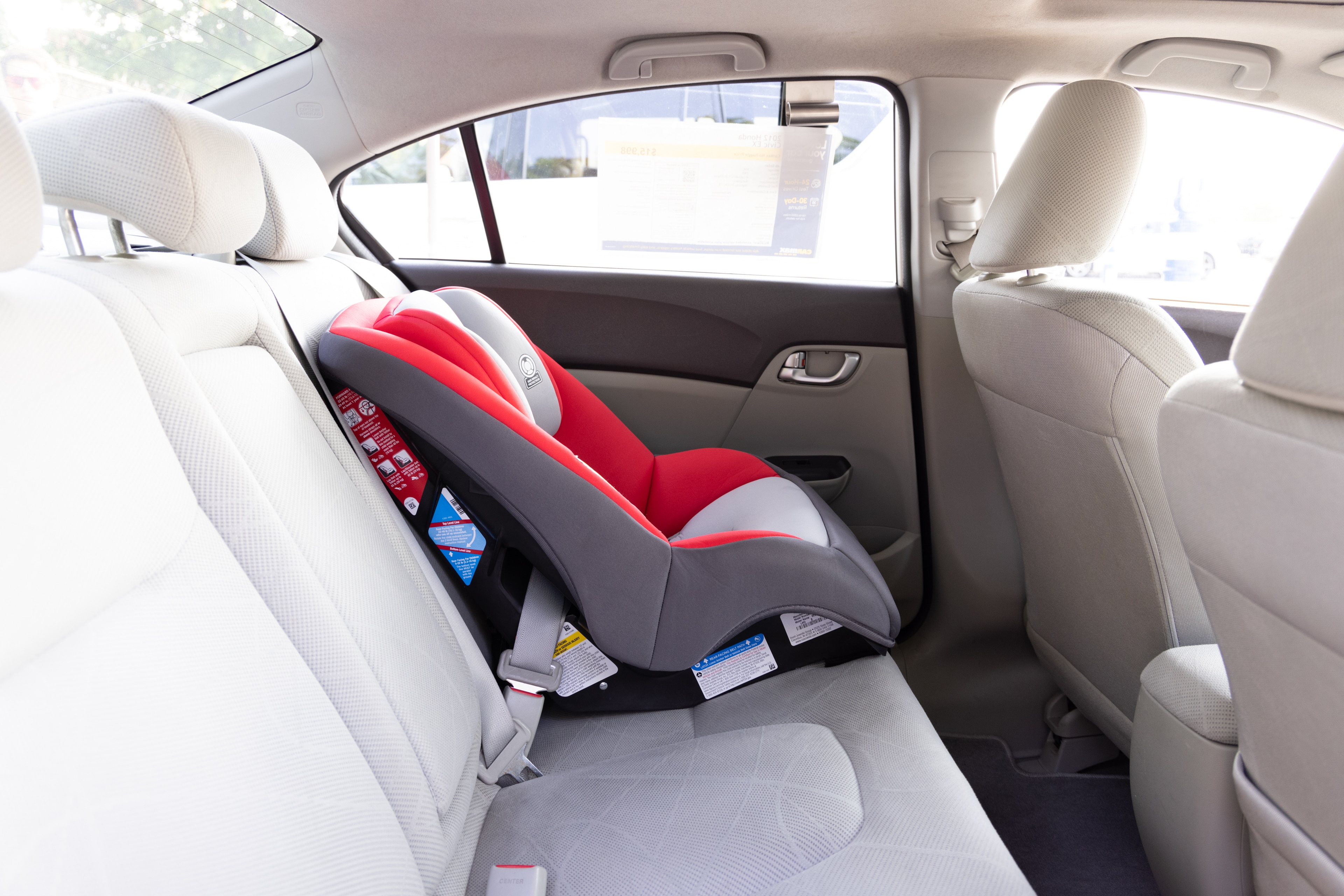 A series of second-row backseat photos is shown including one seating a baby seat and one seating a 6'1" mannequin.