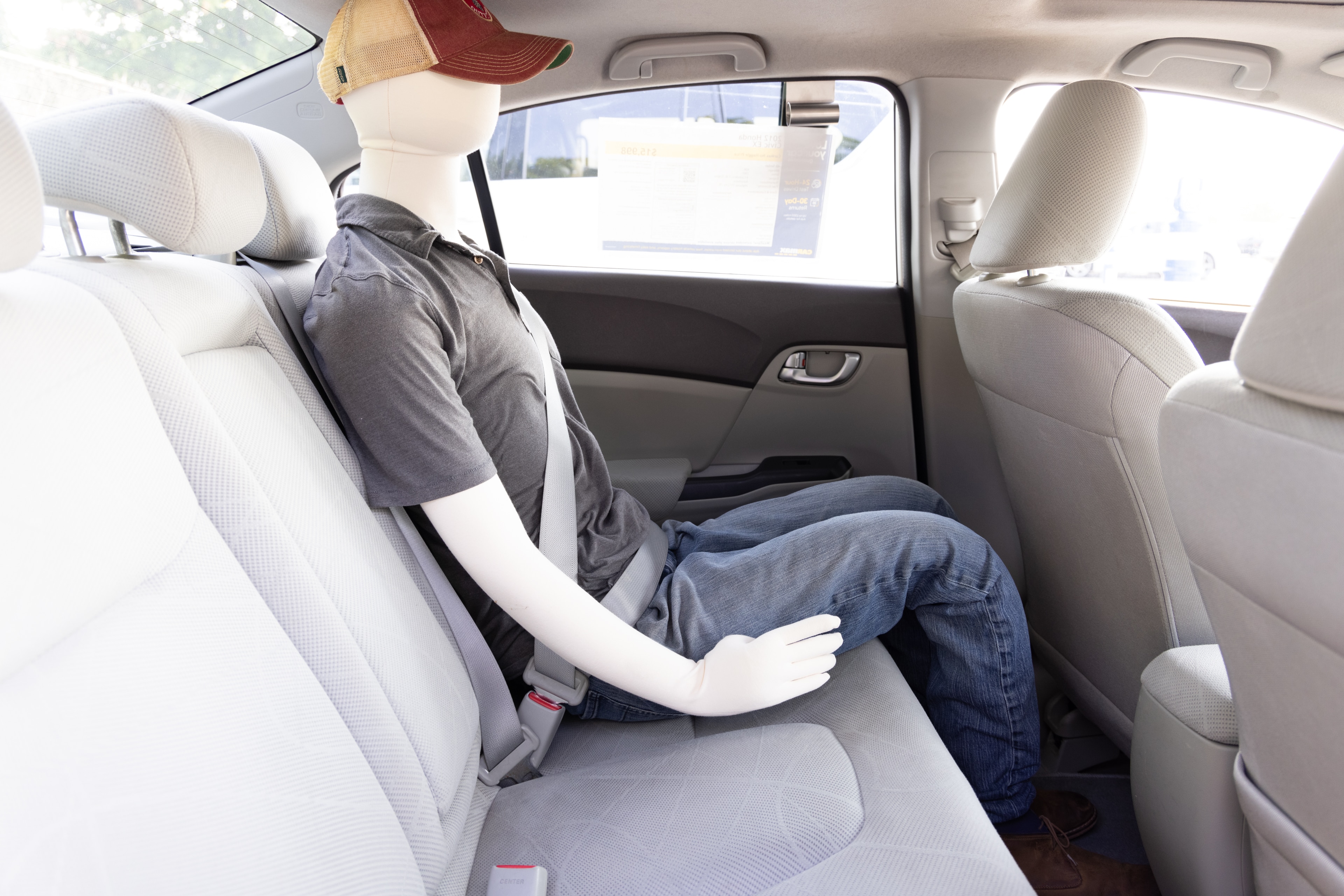 A series of second-row backseat photos is shown including one seating a baby seat and one seating a 6'1" mannequin.