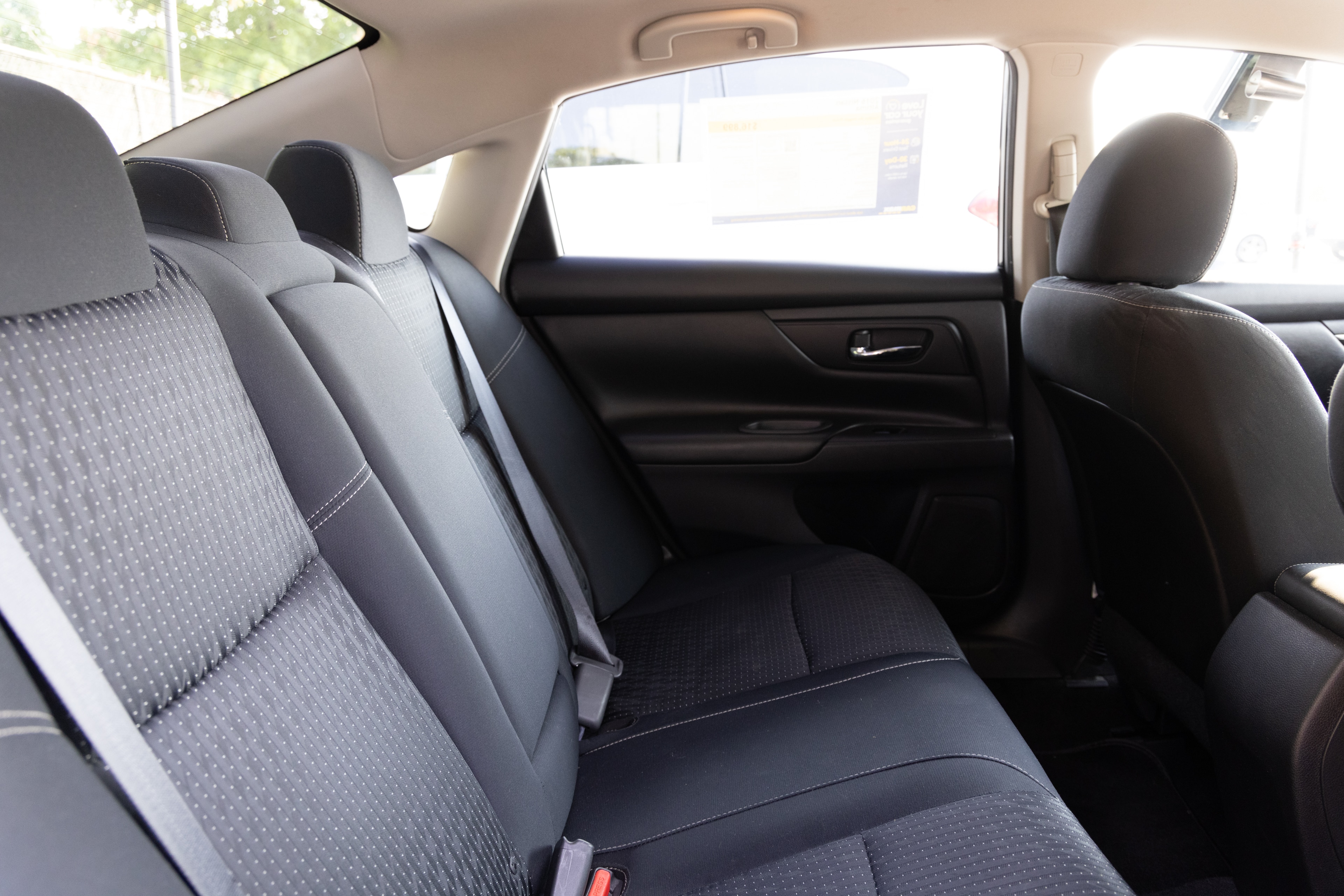 A series of second-row backseat photos is shown including one seating a baby seat and one seating a 6'1" mannequin.