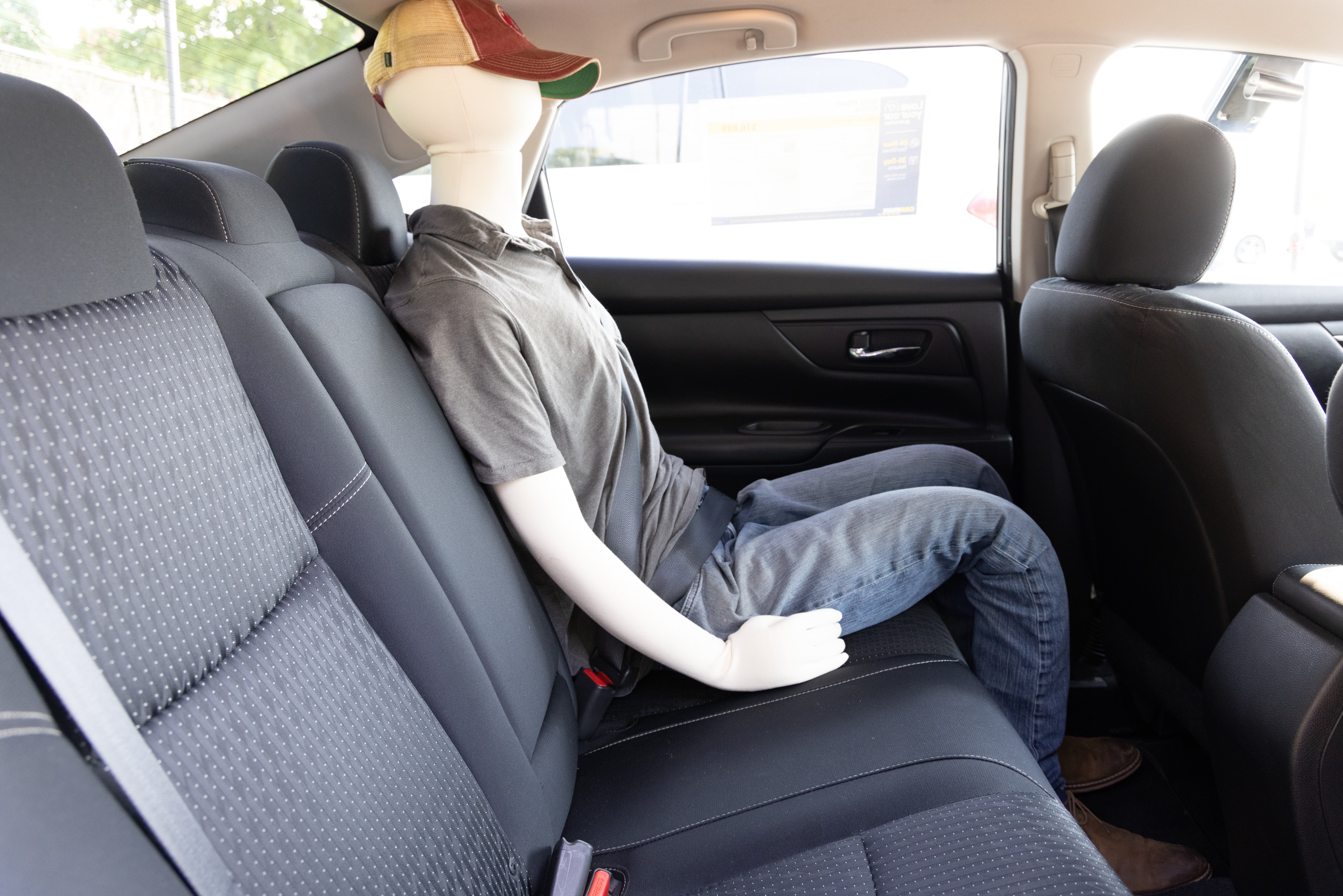 A series of second-row backseat photos is shown including one seating a baby seat and one seating a 6'1" mannequin.