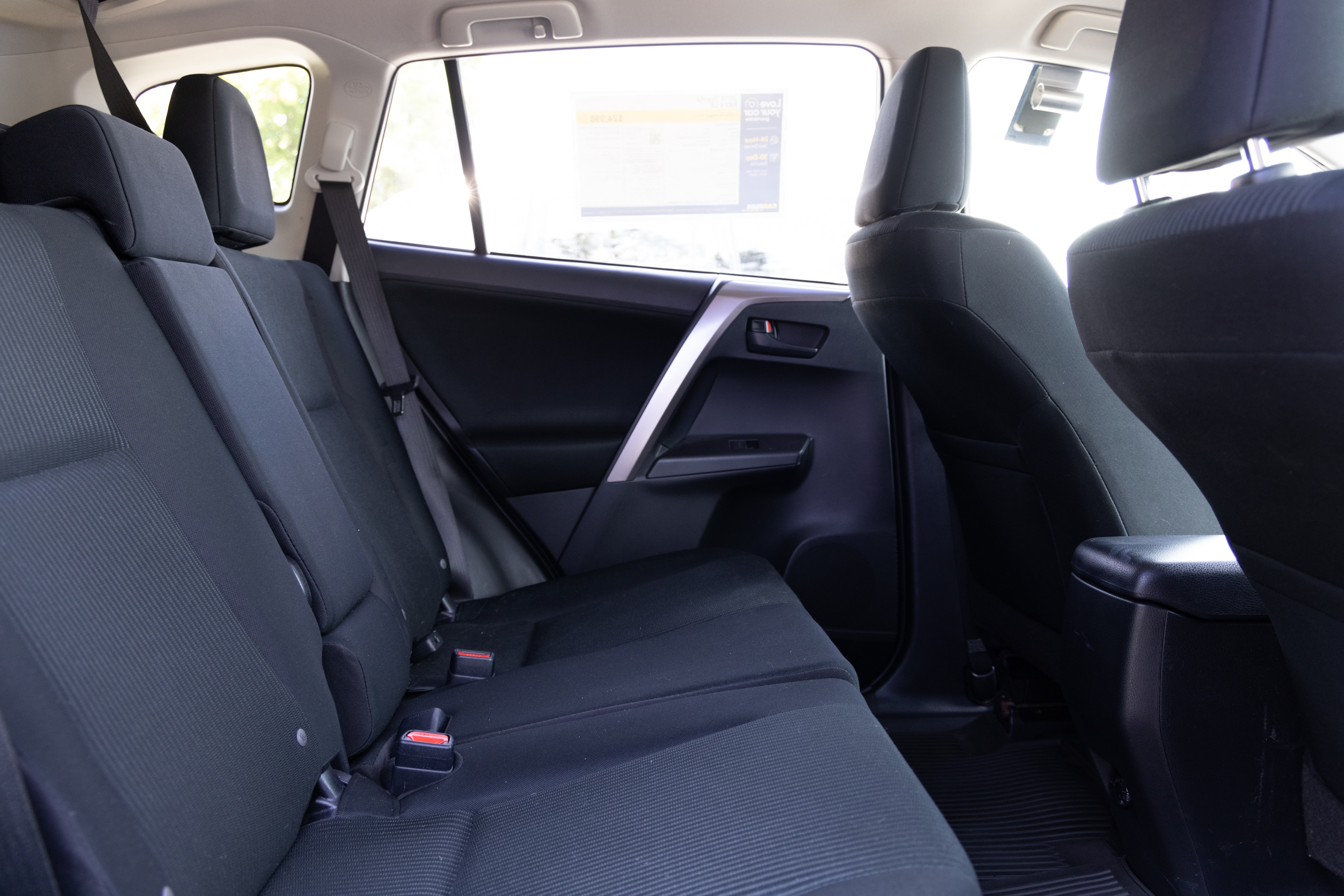 A series of second-row backseat photos is shown including one seating a baby seat and one seating a 6'1" mannequin.