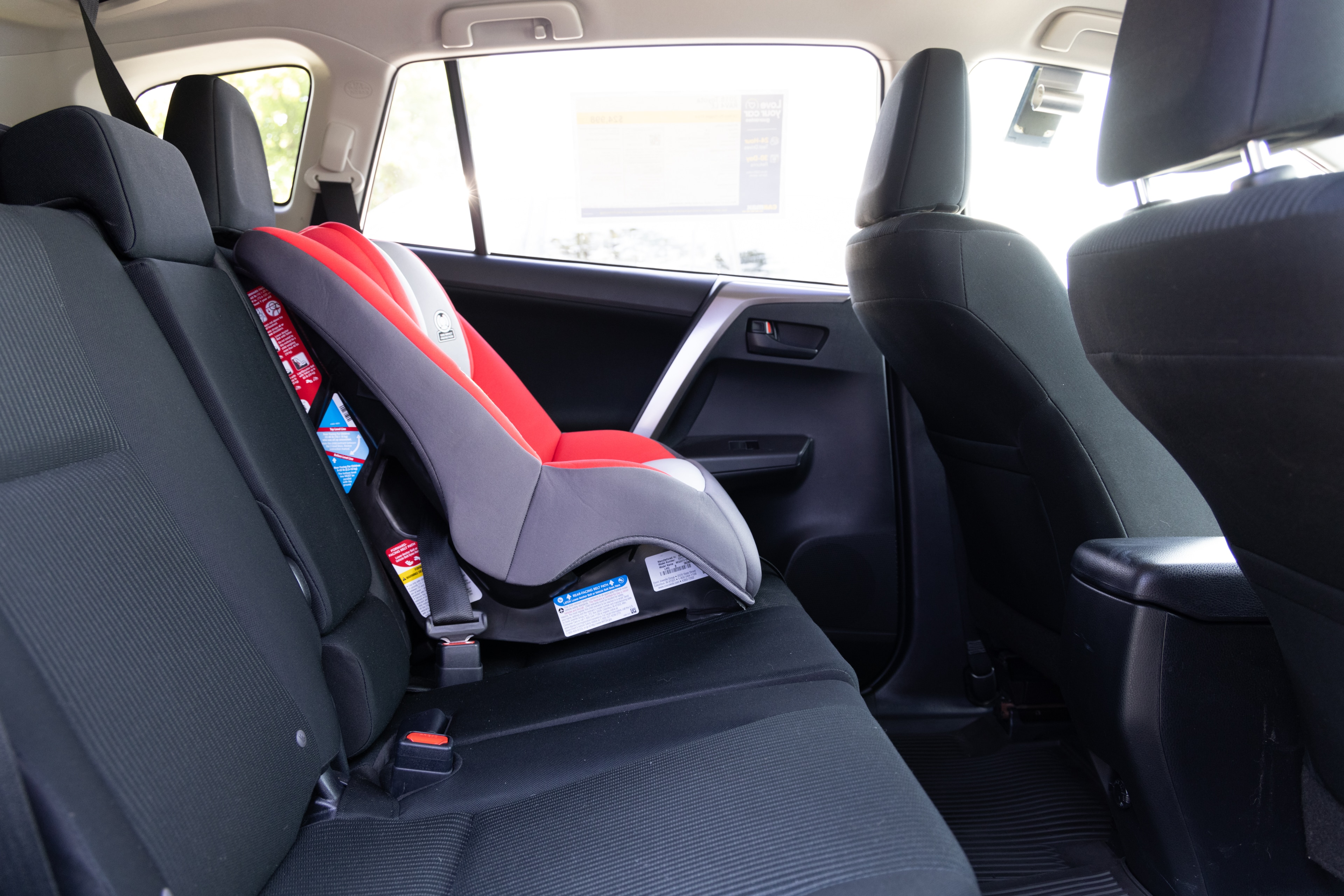A series of second-row backseat photos is shown including one seating a baby seat and one seating a 6'1" mannequin.
