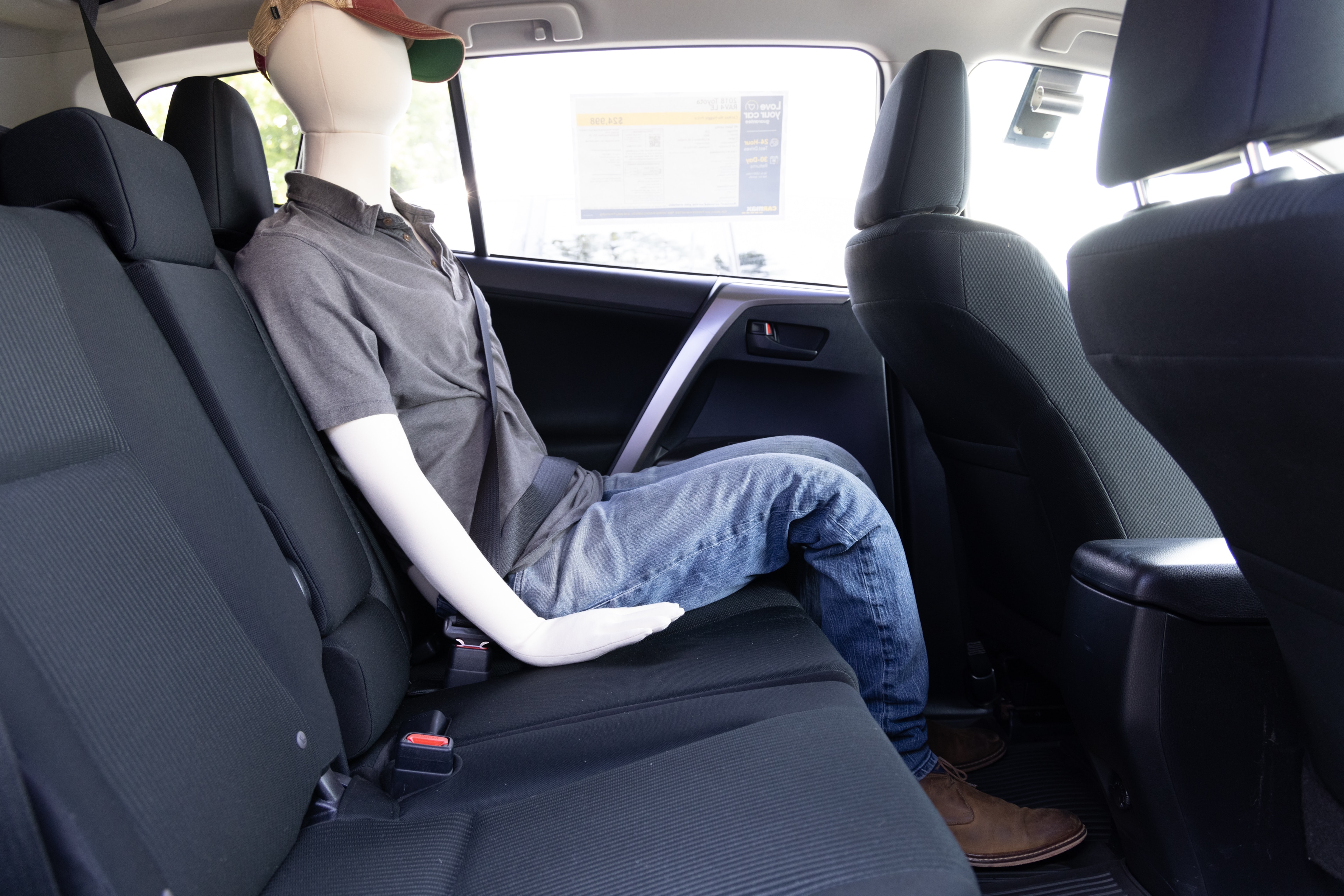 A series of second-row backseat photos is shown including one seating a baby seat and one seating a 6'1" mannequin.