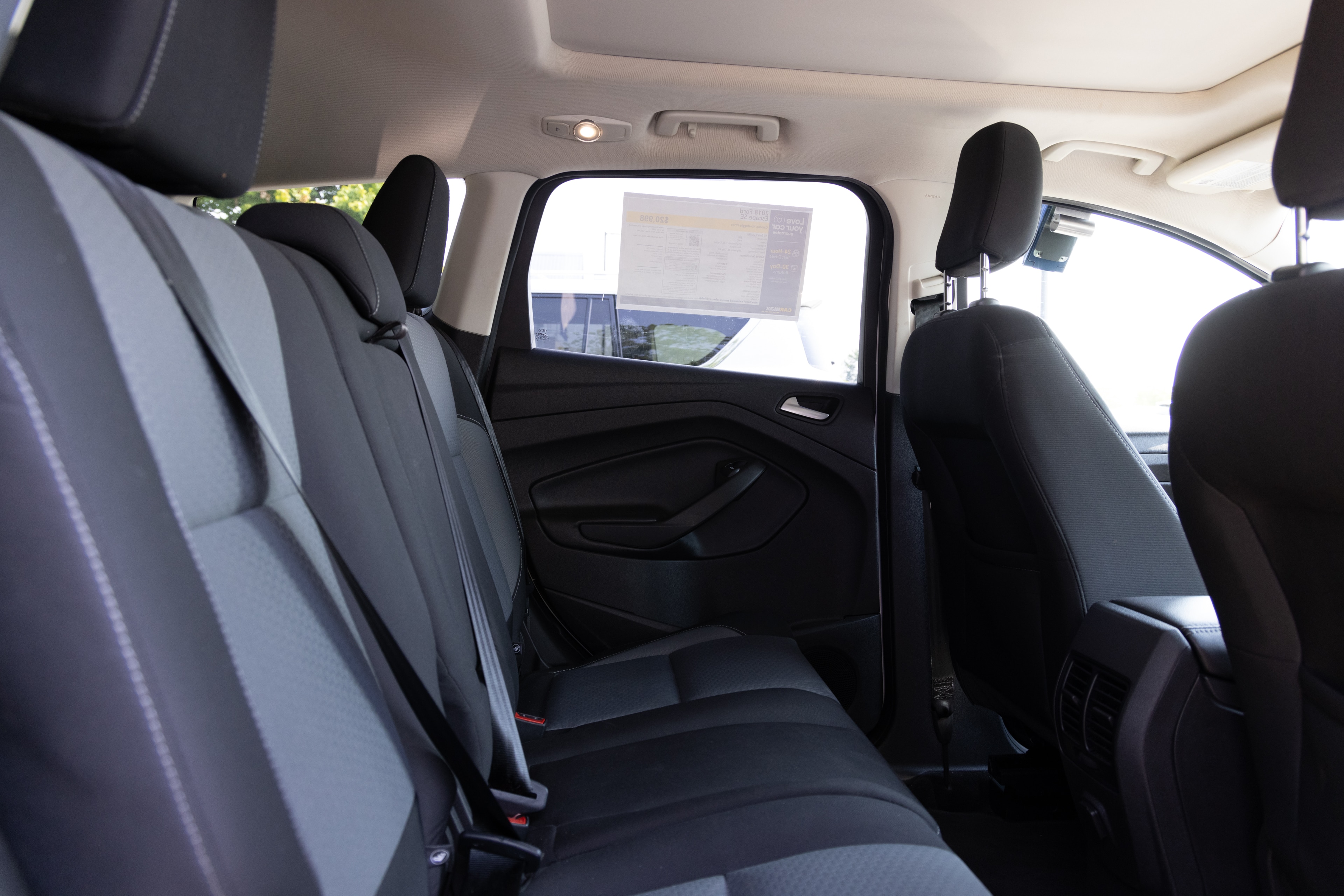 A series of second-row backseat photos is shown including one seating a baby seat and one seating a 6'1" mannequin.