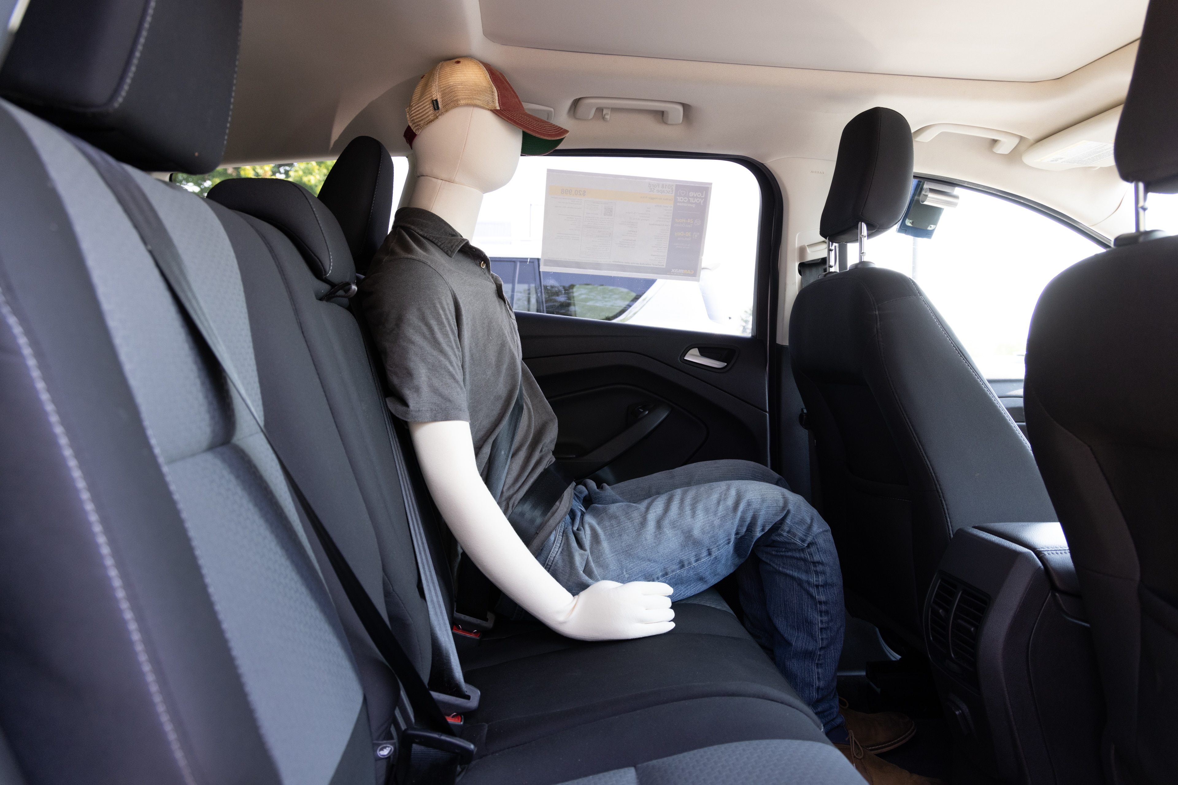 A series of second-row backseat photos is shown including one seating a baby seat and one seating a 6'1" mannequin.