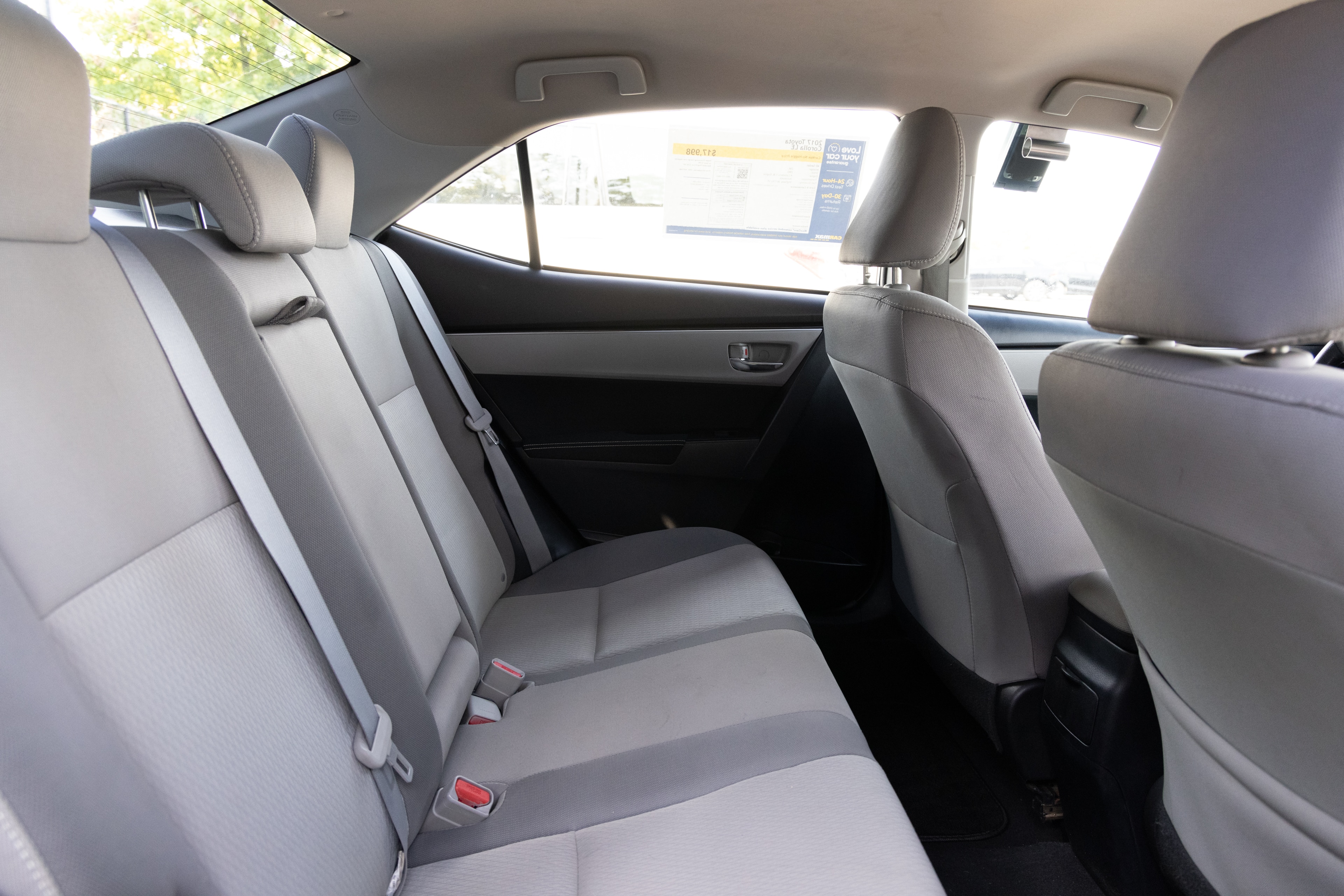 A series of second-row backseat photos is shown including one seating a baby seat and one seating a 6'1" mannequin.
