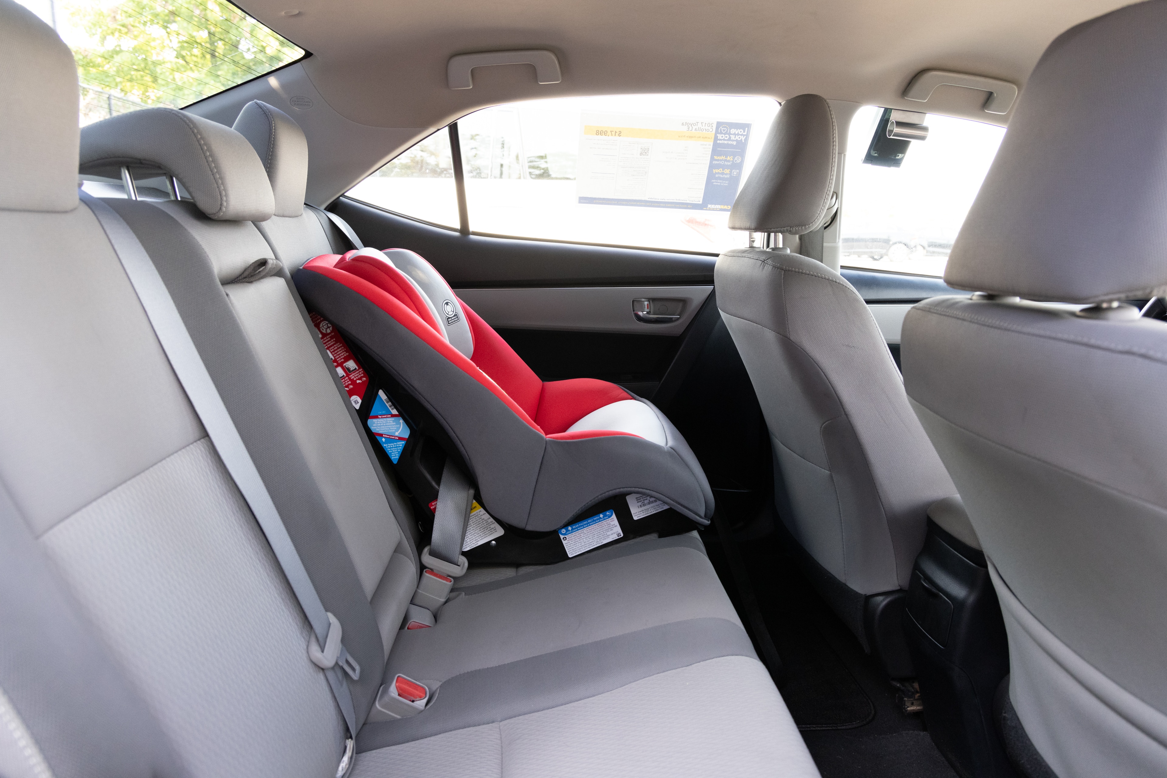 A series of second-row backseat photos is shown including one seating a baby seat and one seating a 6'1" mannequin.