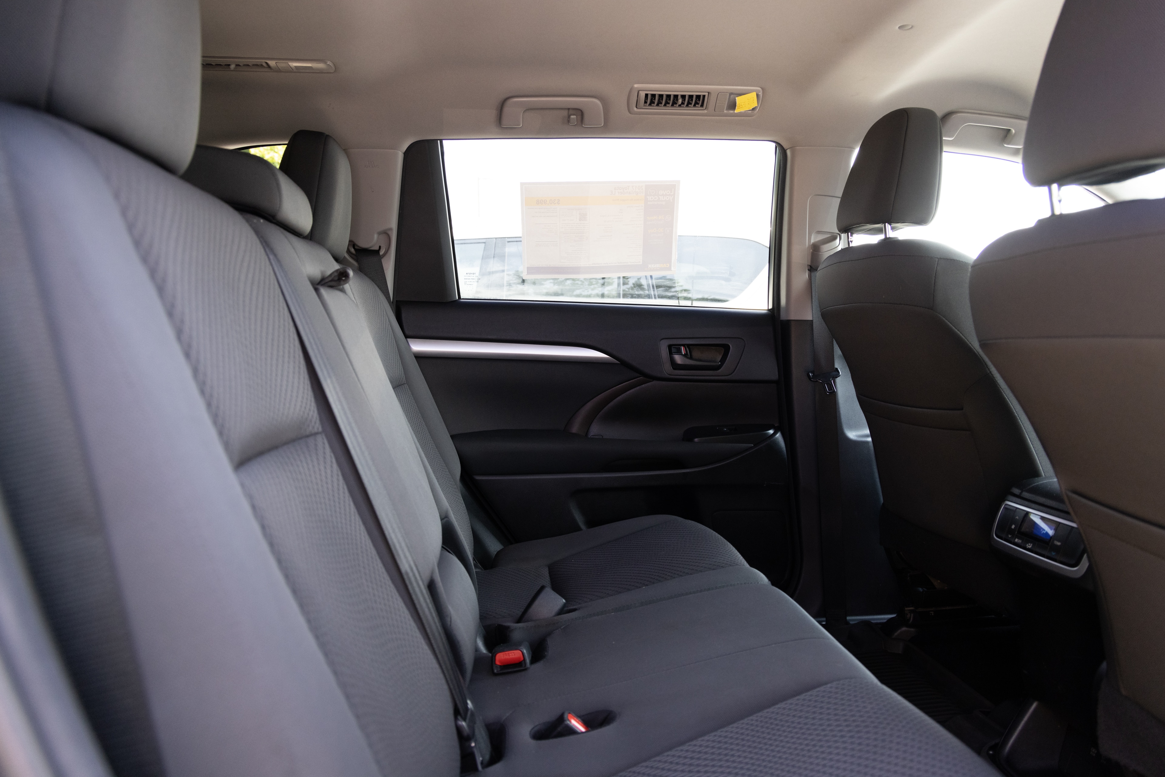 A series of second-row backseat photos is shown including one seating a baby seat and one seating a 6'1" mannequin.