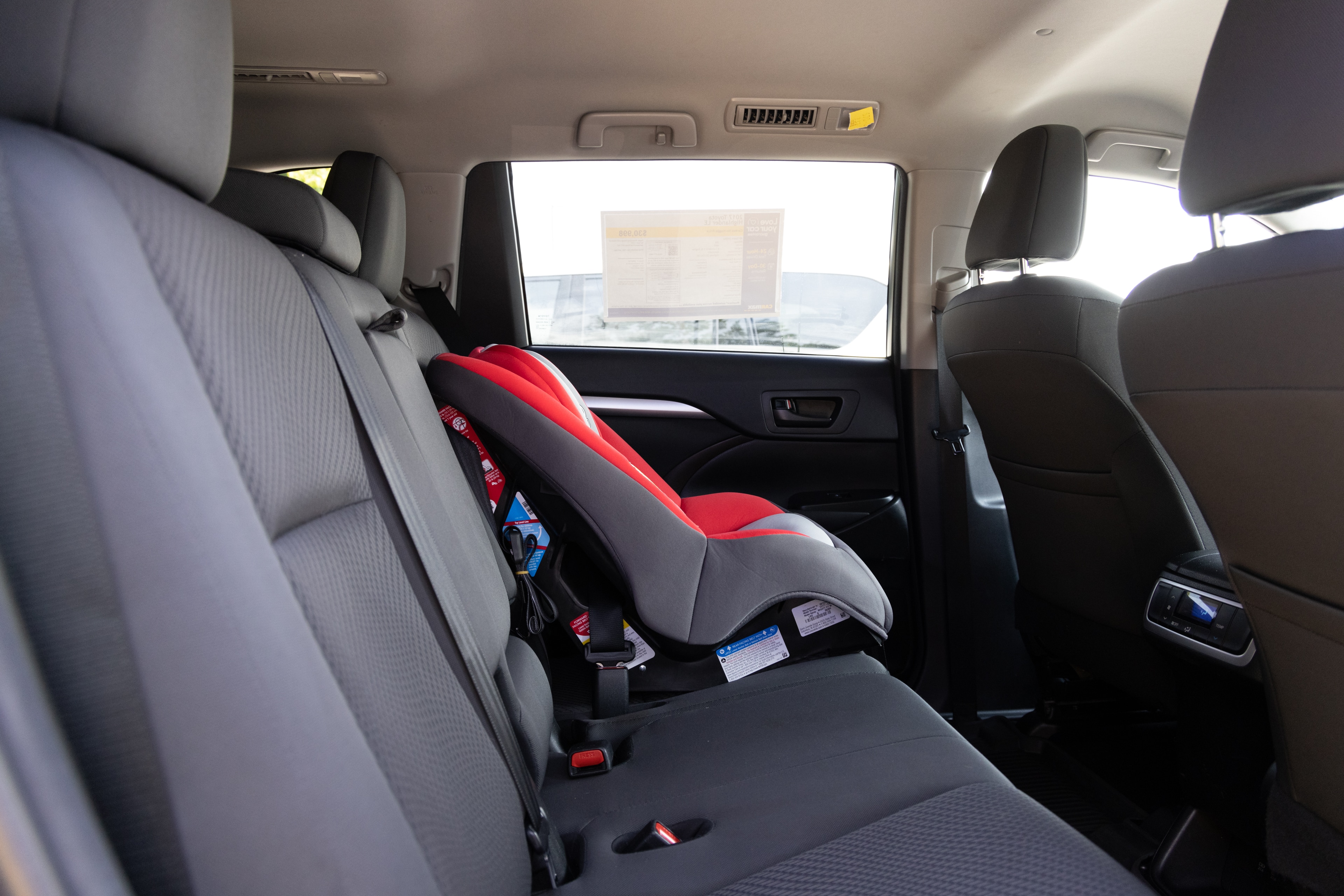 A series of second-row backseat photos is shown including one seating a baby seat and one seating a 6'1" mannequin.