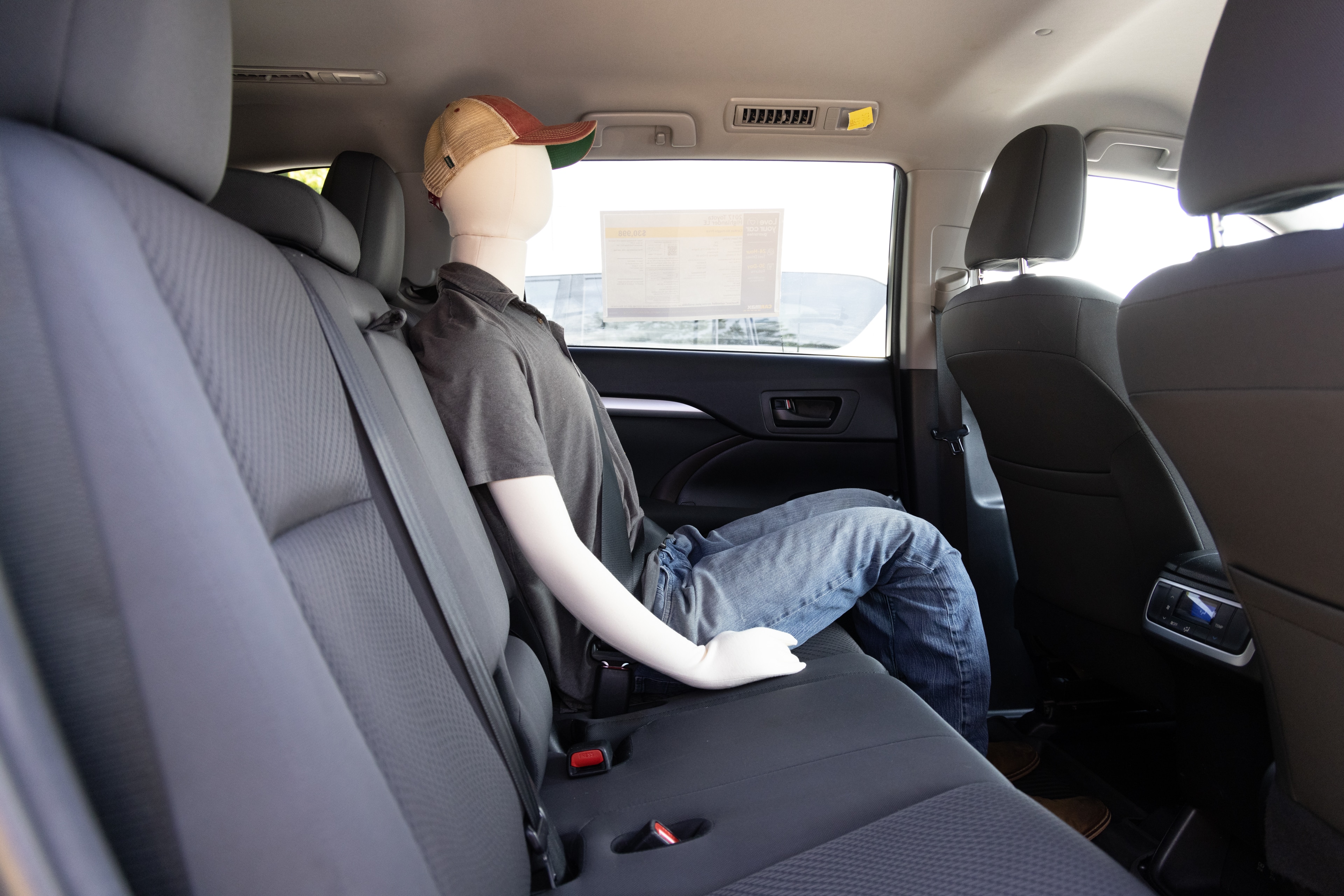 A series of second-row backseat photos is shown including one seating a baby seat and one seating a 6'1" mannequin.