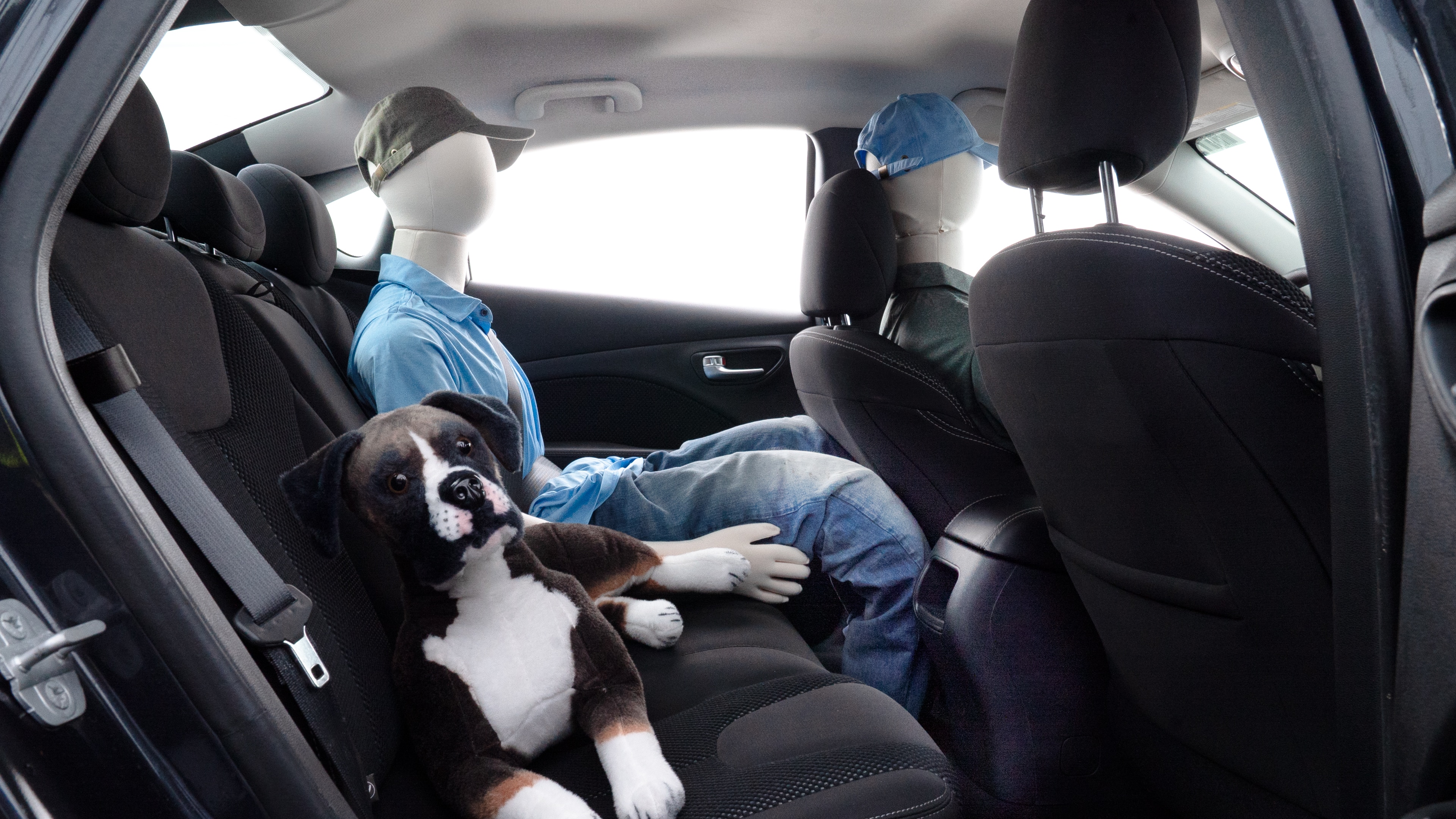 A series of second-row backseat photos is shown including one seating a baby seat and one seating a 6'1" mannequin.