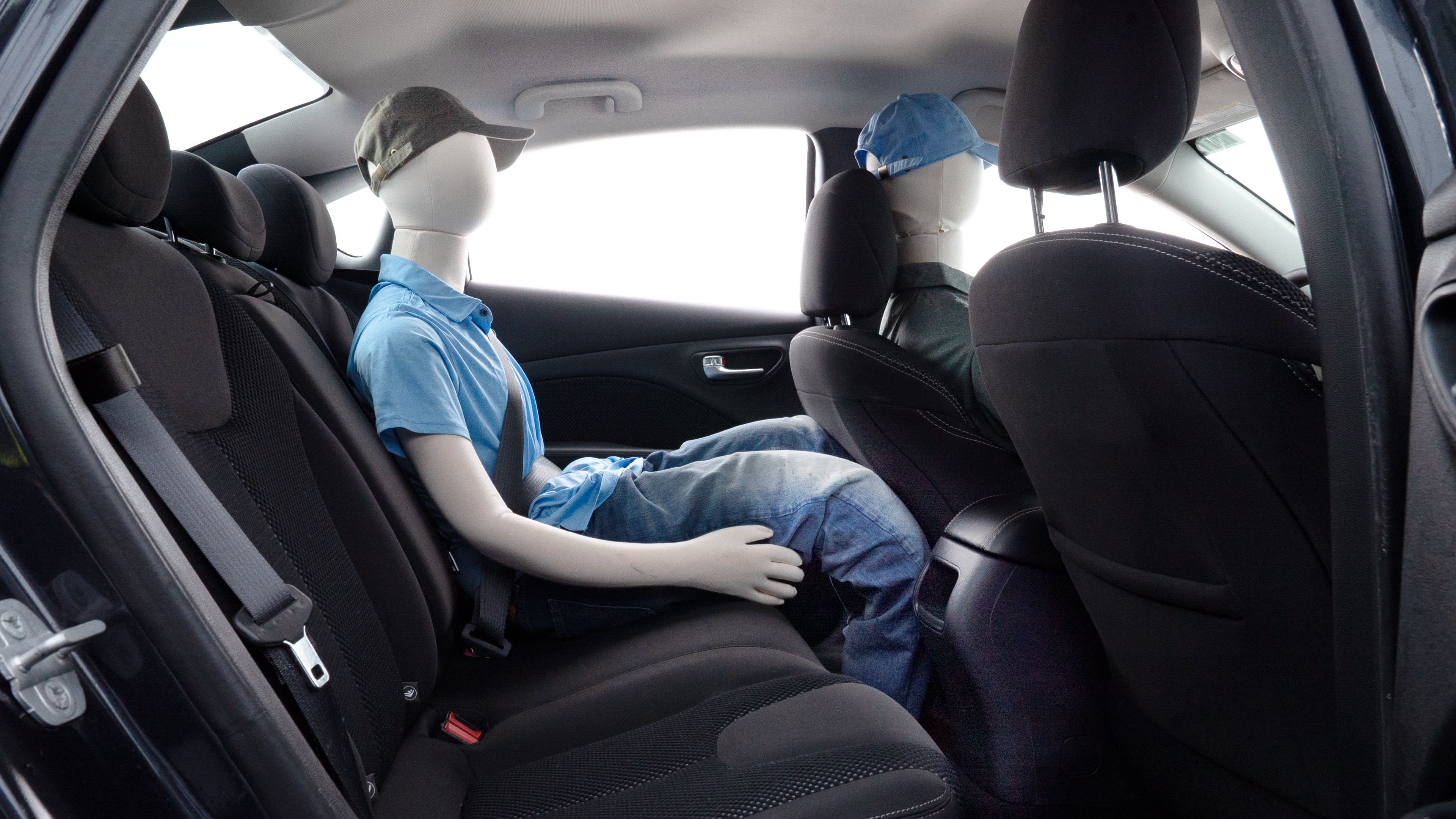 A series of second-row backseat photos is shown including one seating a baby seat and one seating a 6'1" mannequin.
