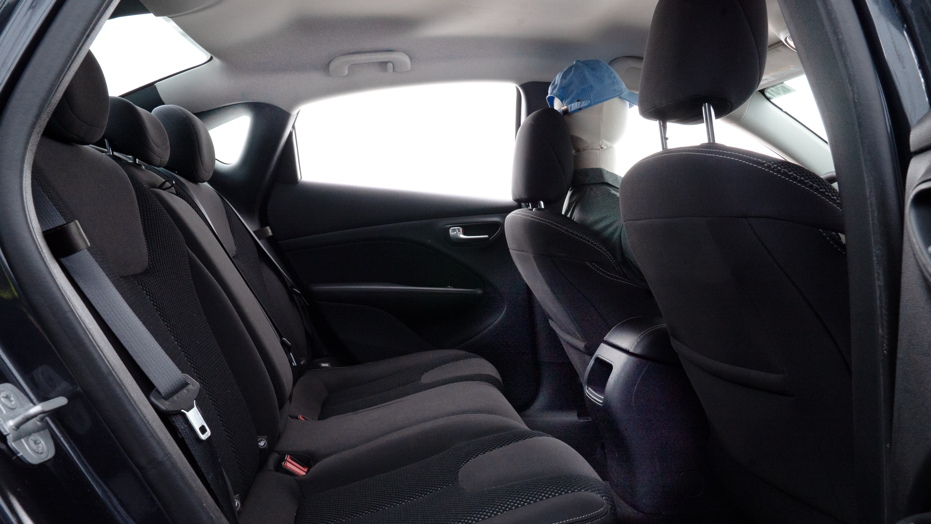 A series of second-row backseat photos is shown including one seating a baby seat and one seating a 6'1" mannequin.