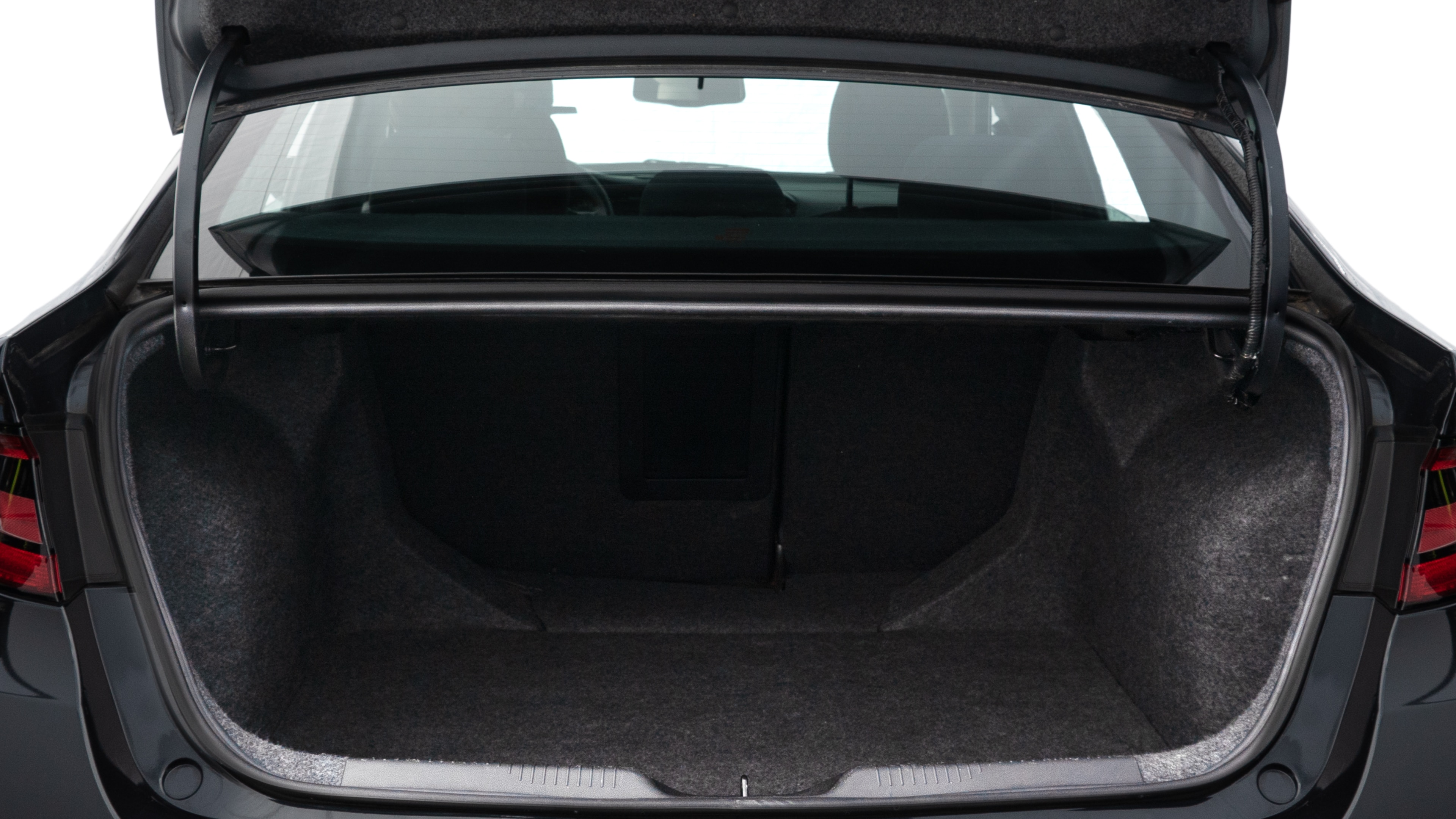 The trunk lid is open showing full view of the trunk. A baby stroller, three grocery carriers, two camping chairs in the carrying bag, and a set of golf clubs are placed inside.