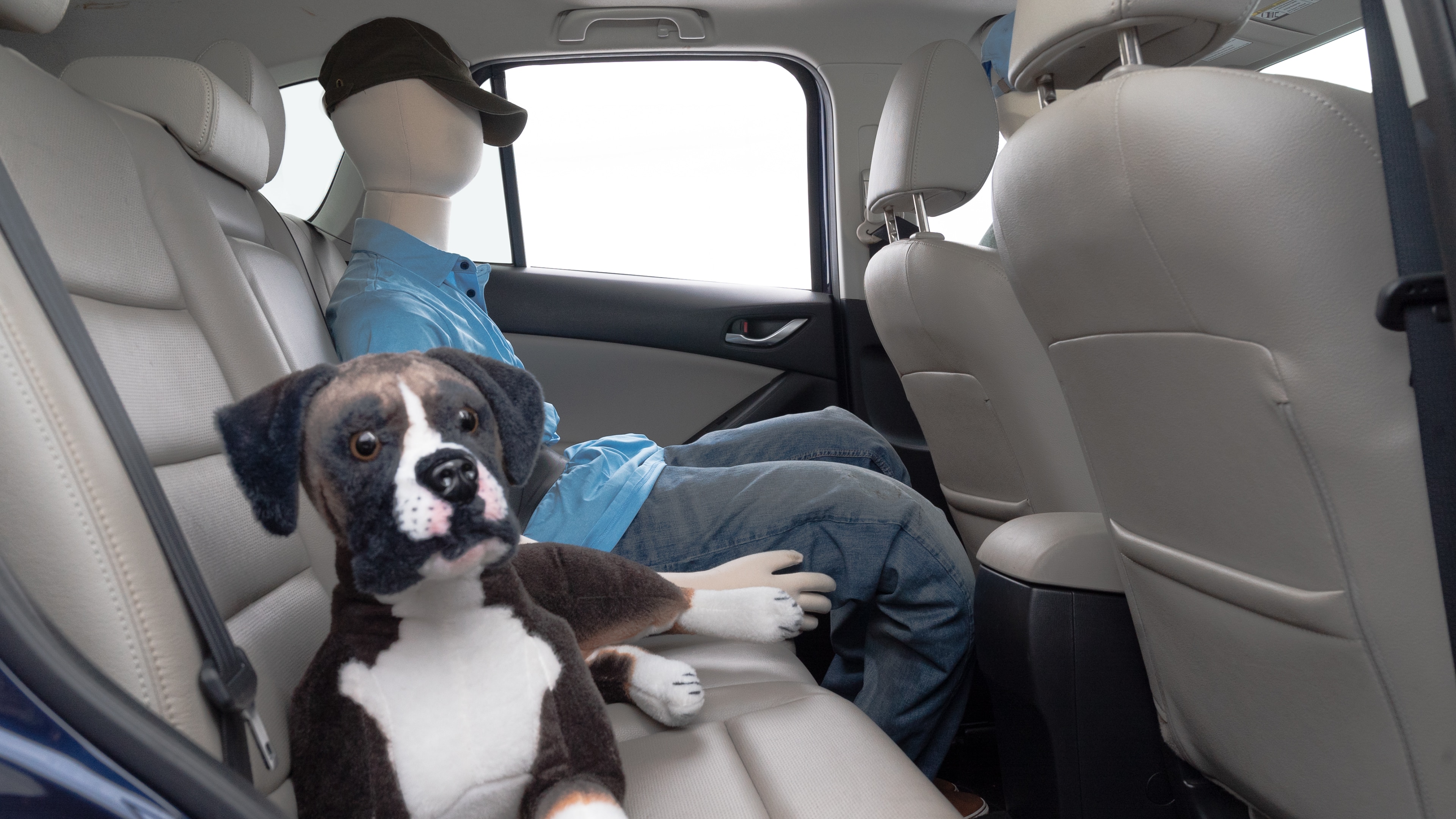 A series of second-row backseat photos is shown including one seating a baby seat and one seating a 6'1" mannequin.
