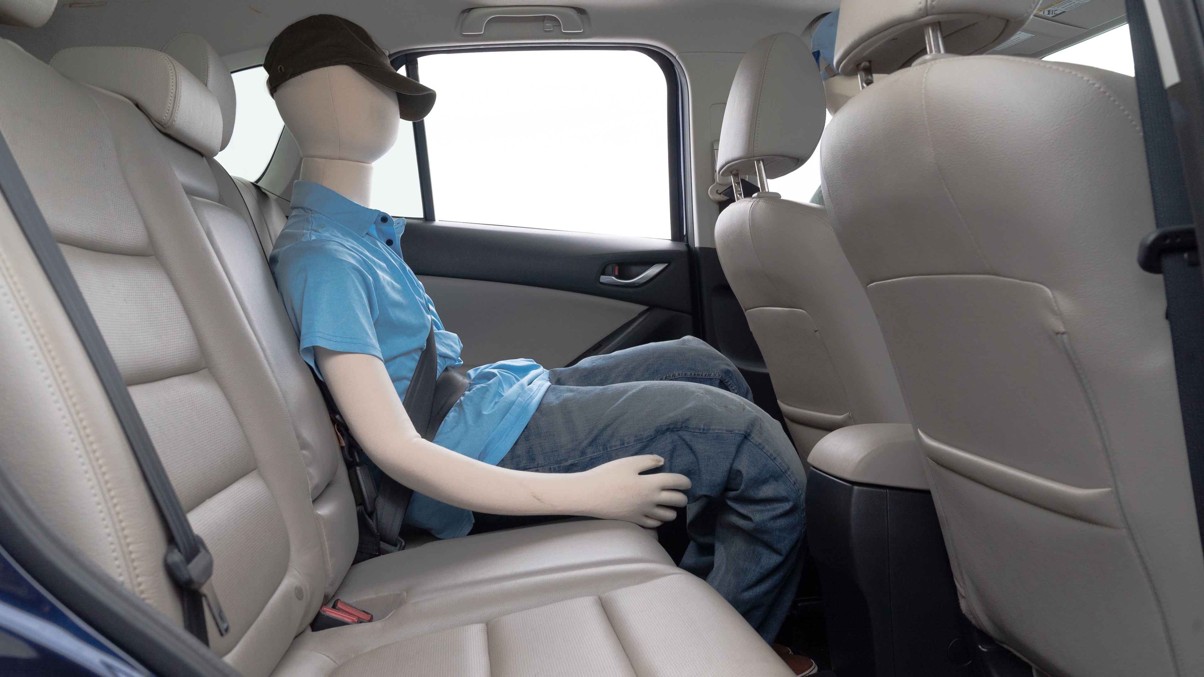 A series of second-row backseat photos is shown including one seating a baby seat and one seating a 6'1" mannequin.