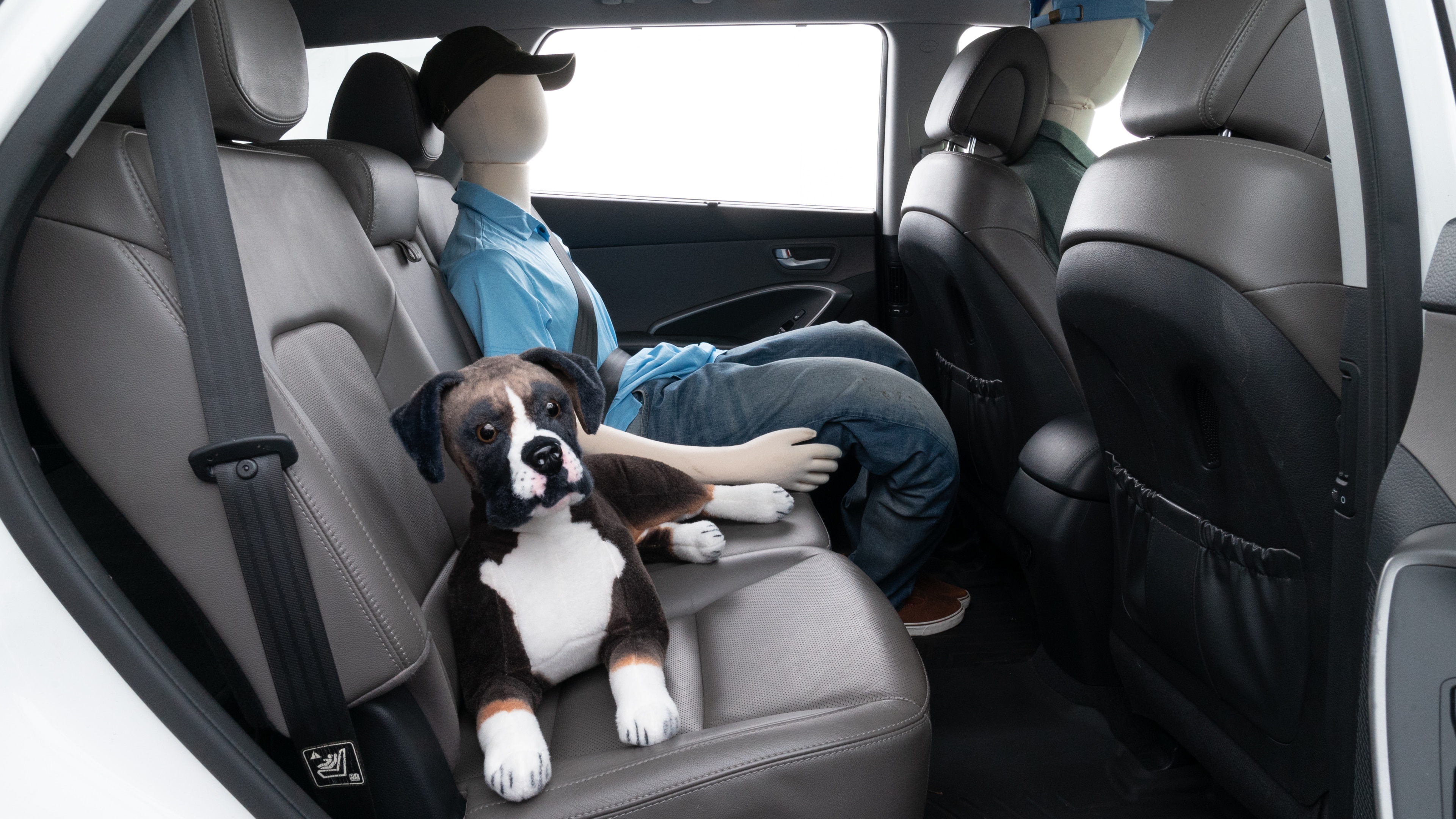 A series of second-row backseat photos is shown including one seating a baby seat and one seating a 6'1" mannequin.