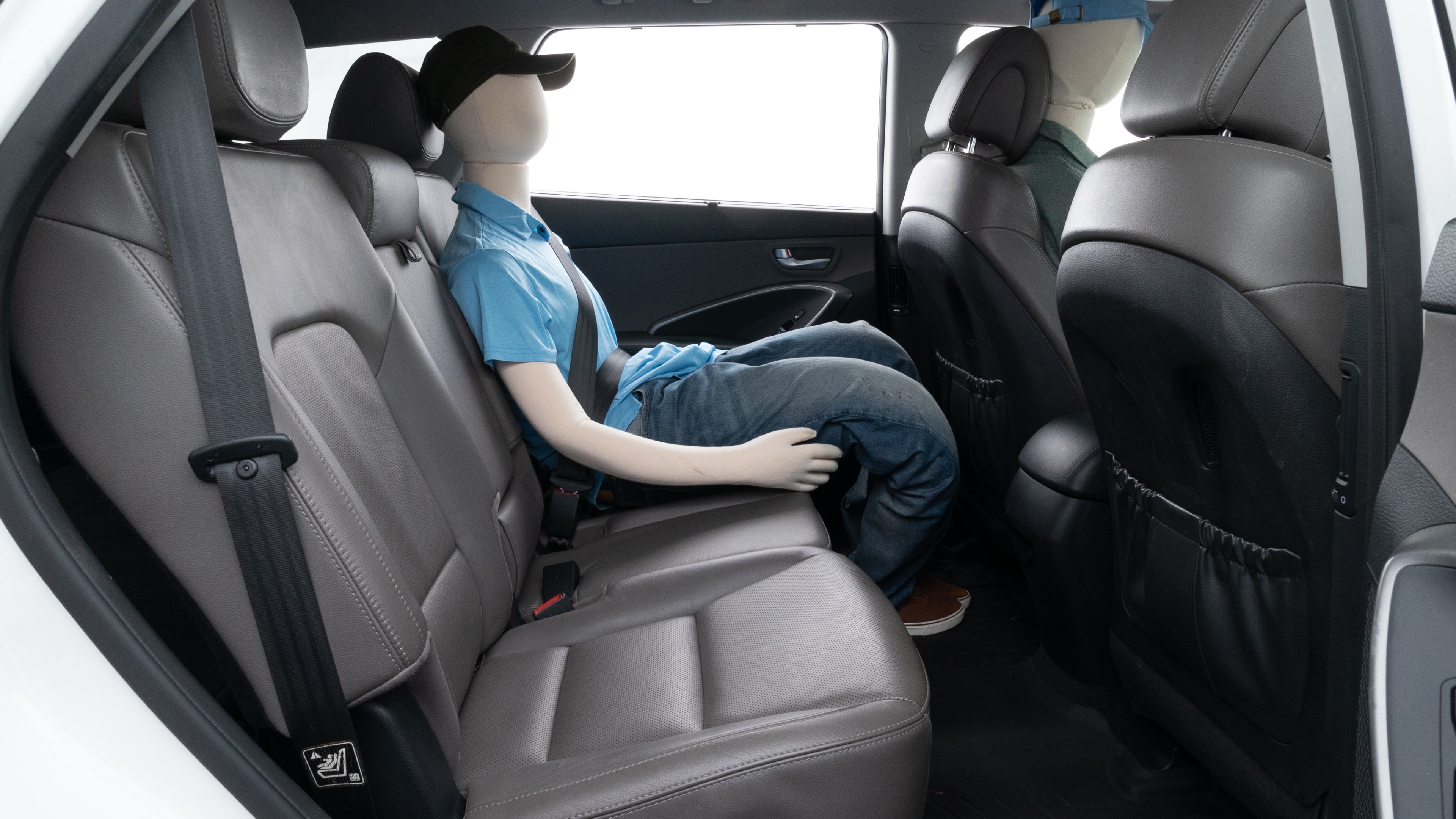 A series of second-row backseat photos is shown including one seating a baby seat and one seating a 6'1" mannequin.