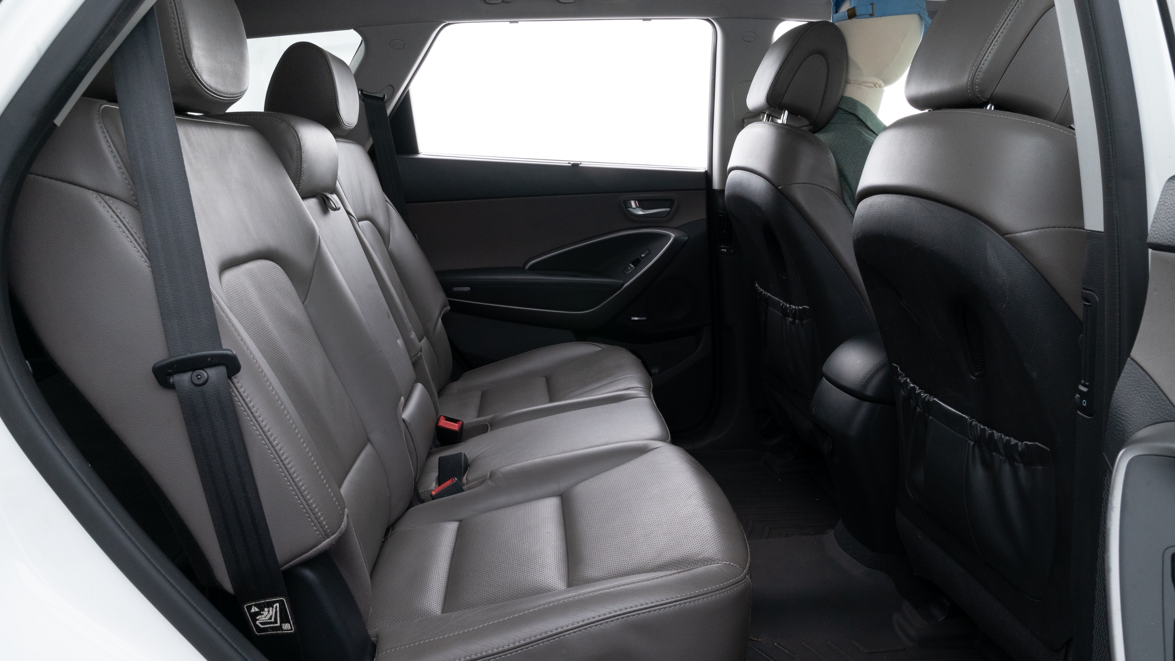 A series of second-row backseat photos is shown including one seating a baby seat and one seating a 6'1" mannequin.