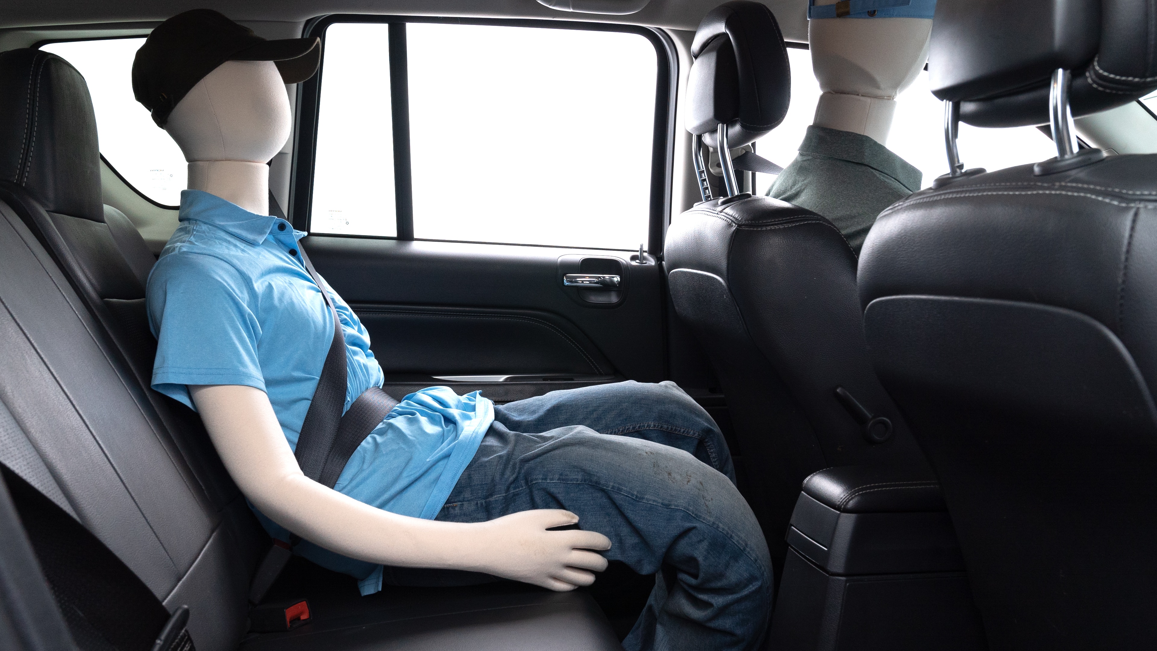 A series of second-row backseat photos is shown including one seating a baby seat and one seating a 6'1" mannequin.