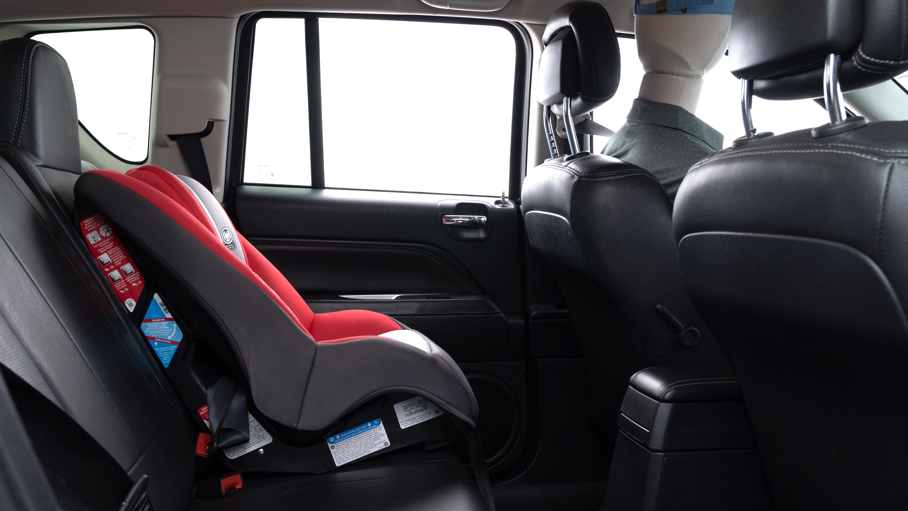 A series of second-row backseat photos is shown including one seating a baby seat and one seating a 6'1" mannequin.