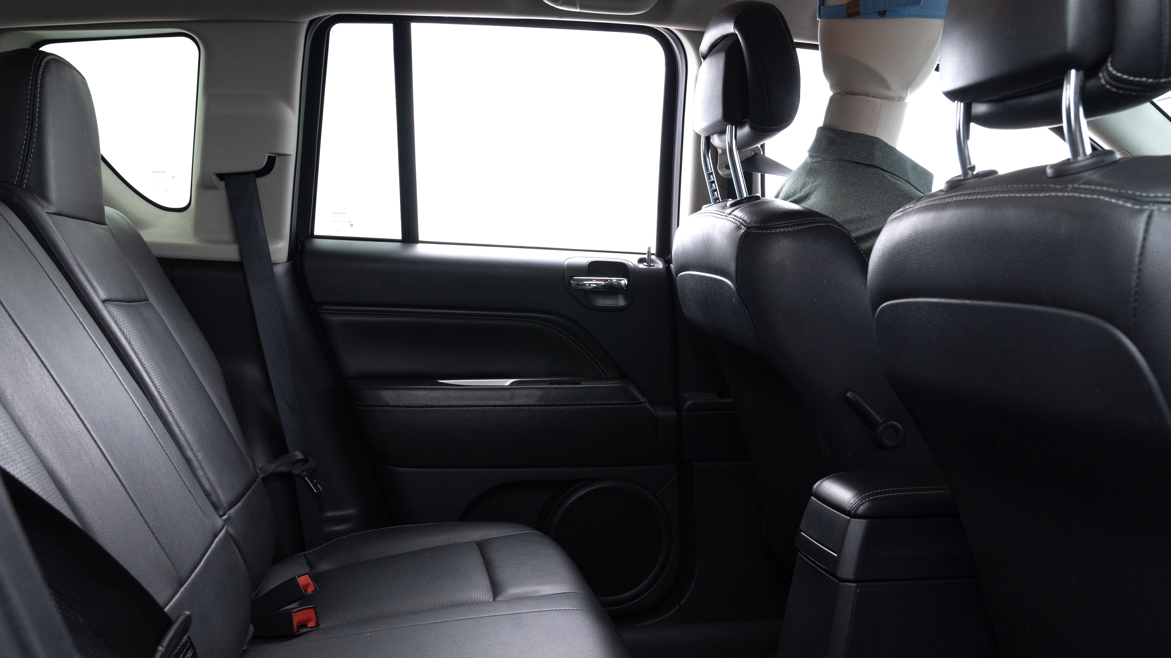 A series of second-row backseat photos is shown including one seating a baby seat and one seating a 6'1" mannequin.
