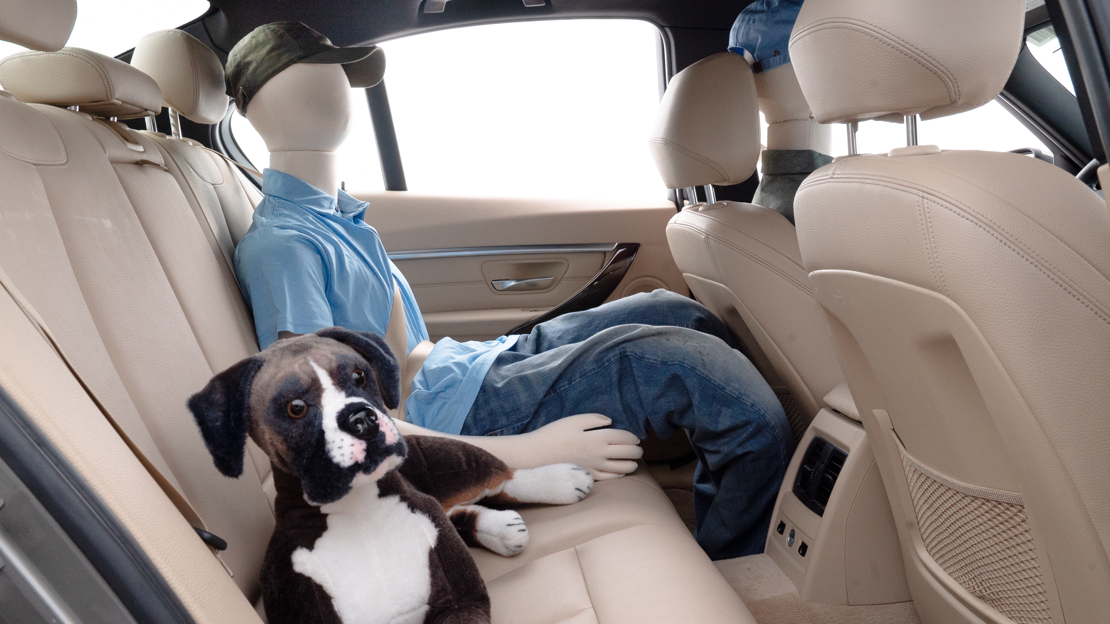 A series of second-row backseat photos is shown including one seating a baby seat and one seating a 6'1" mannequin.
