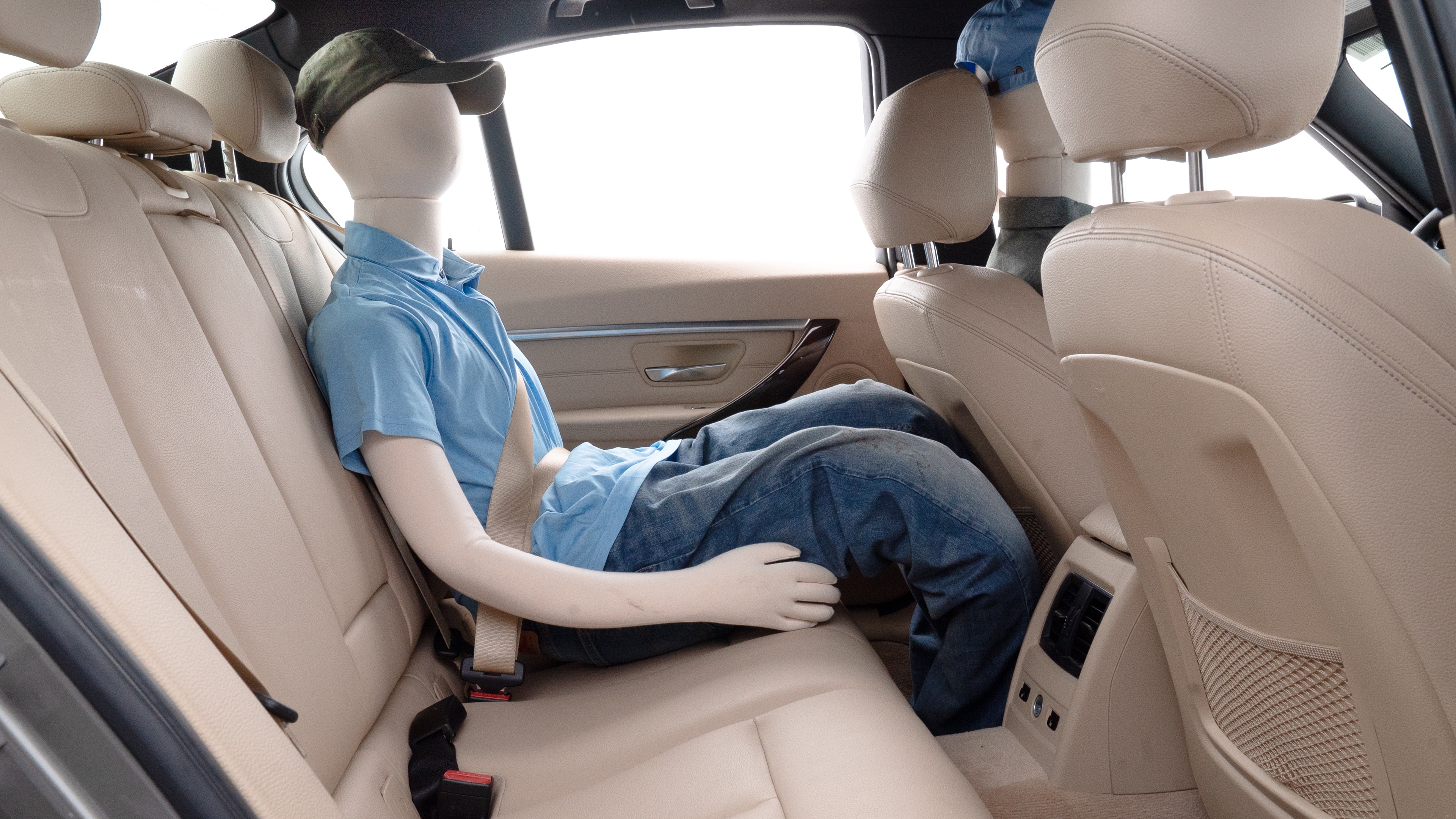 A series of second-row backseat photos is shown including one seating a baby seat and one seating a 6'1" mannequin.