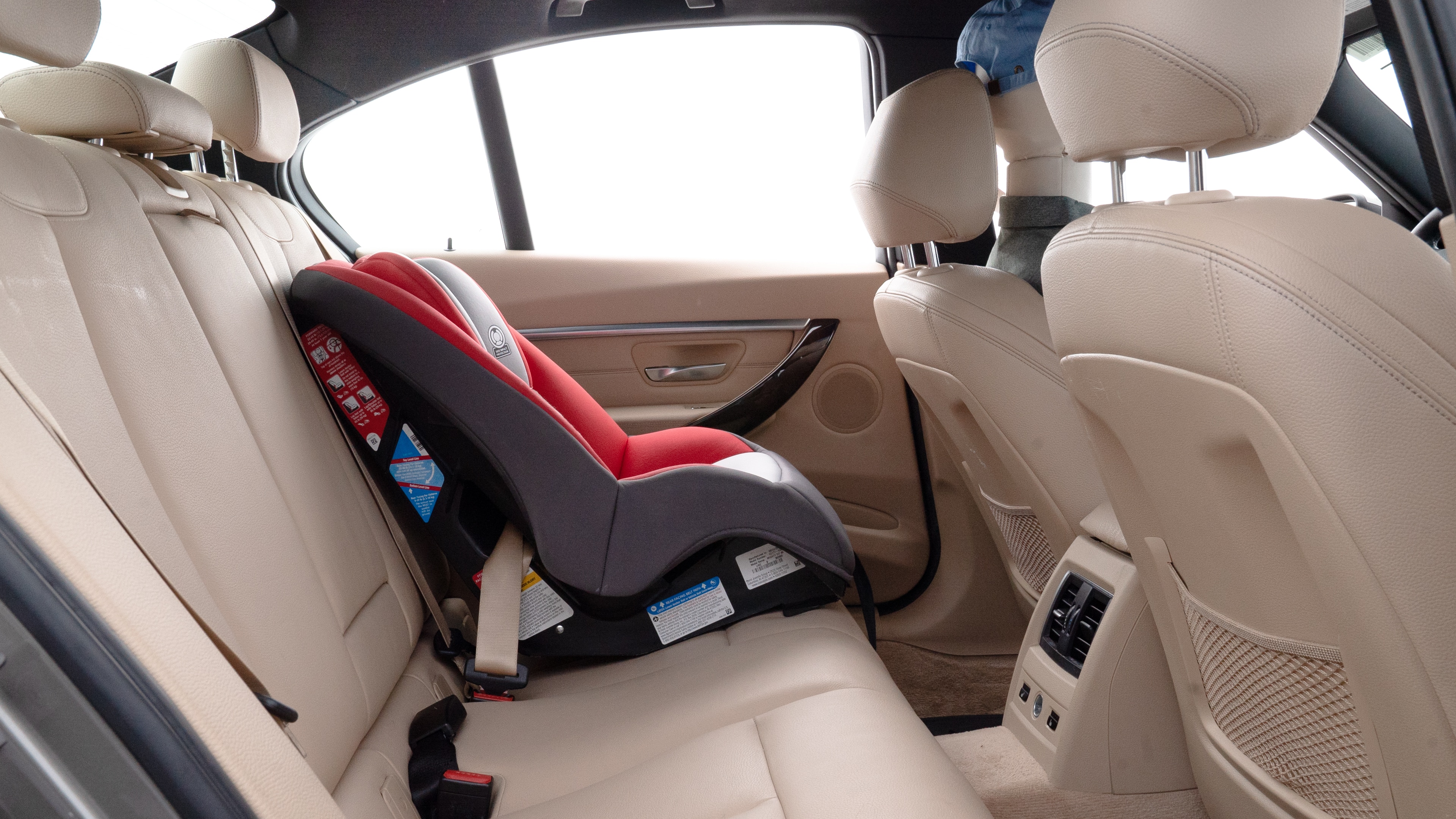 A series of second-row backseat photos is shown including one seating a baby seat and one seating a 6'1" mannequin.