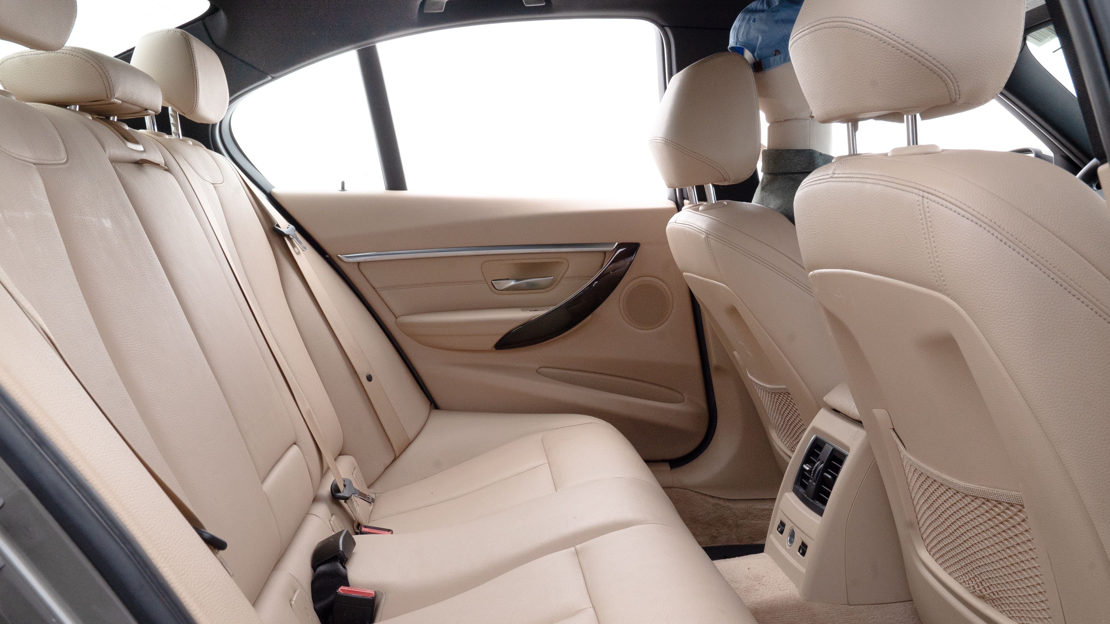 A series of second-row backseat photos is shown including one seating a baby seat and one seating a 6'1" mannequin.