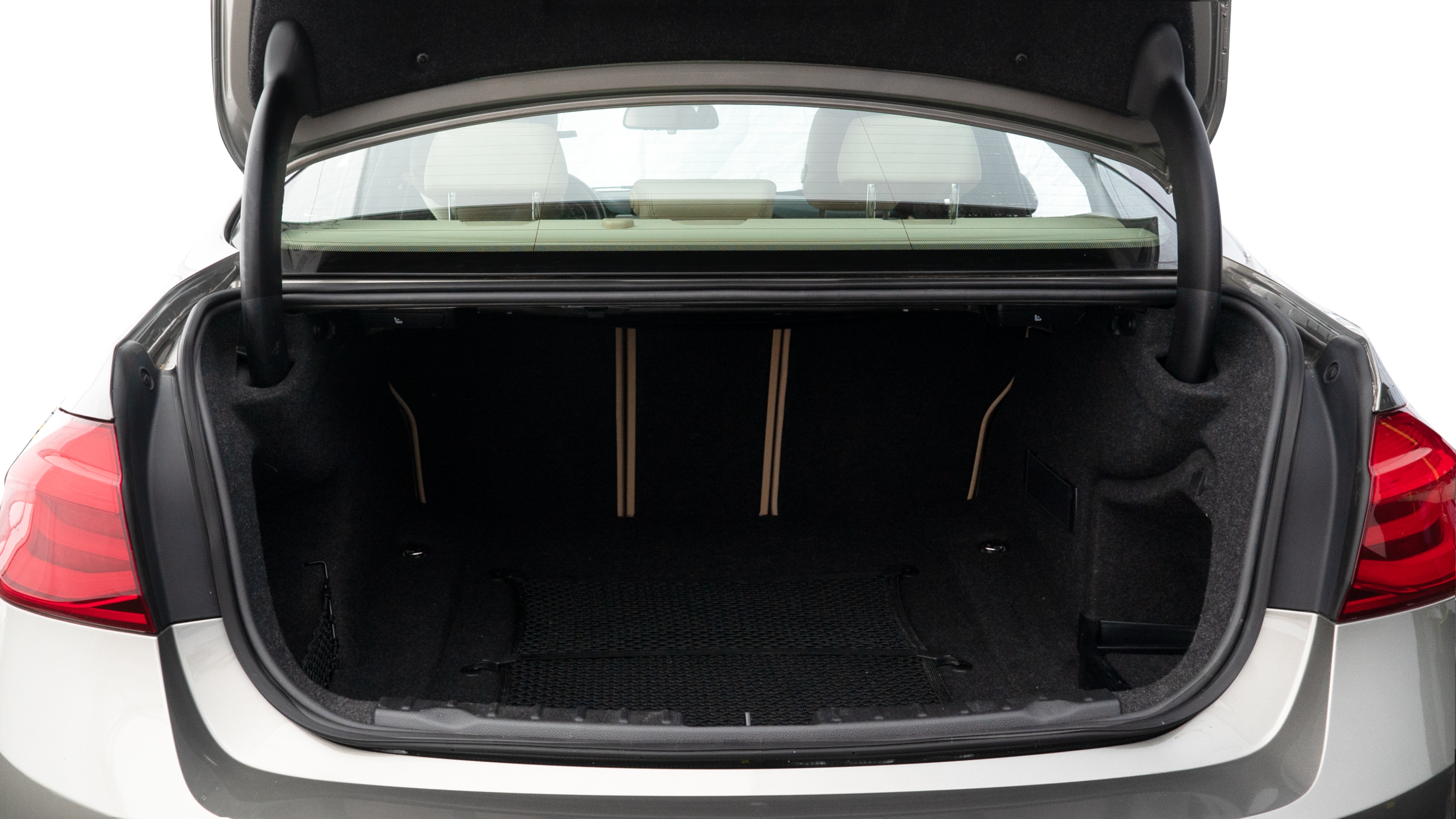 The trunk lid is open showing full view of the trunk. A baby stroller, three grocery carriers, two camping chairs in the carrying bag, and a set of golf clubs are placed inside.