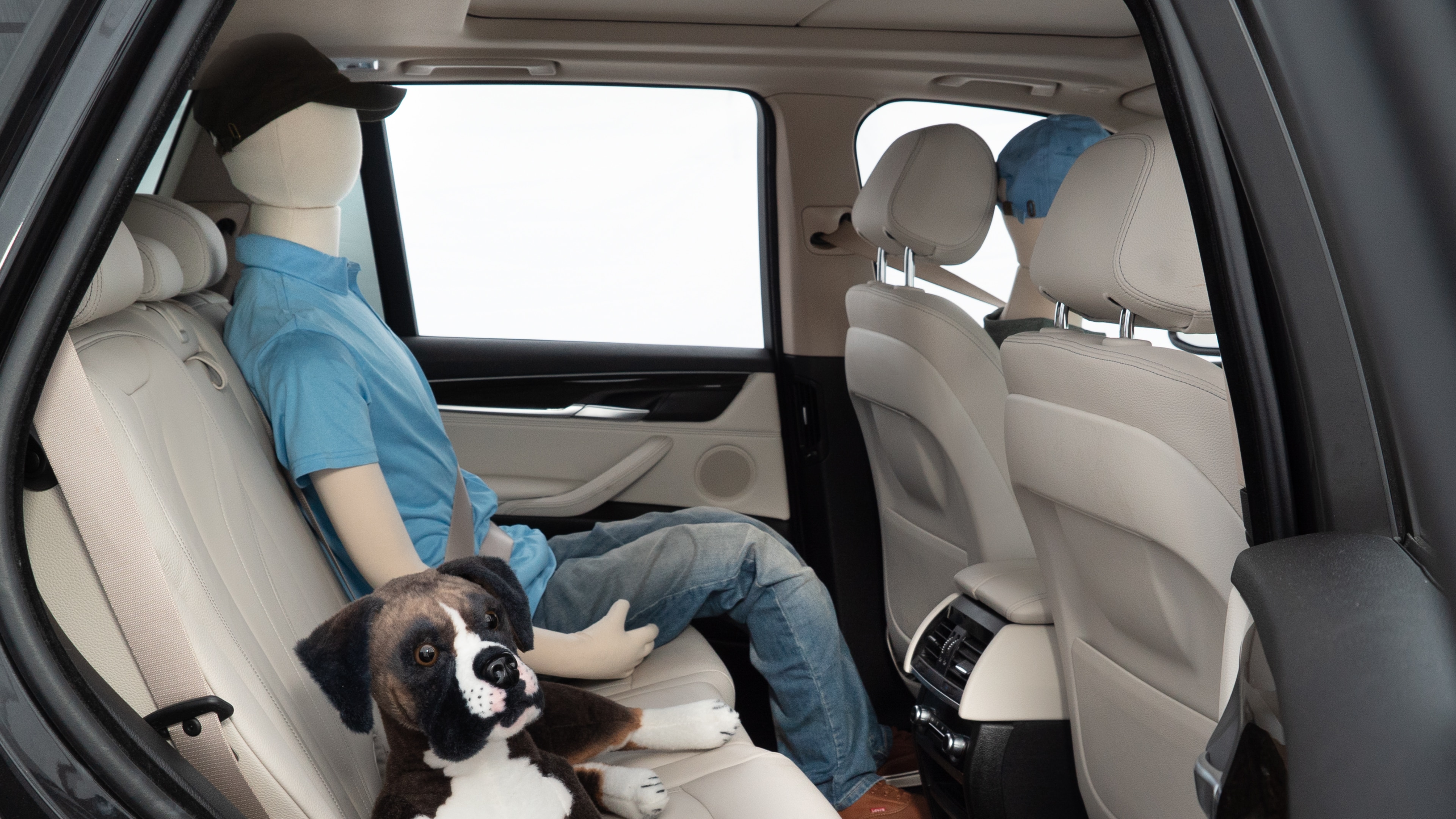 A series of second-row backseat photos is shown including one seating a baby seat and one seating a 6'1" mannequin.