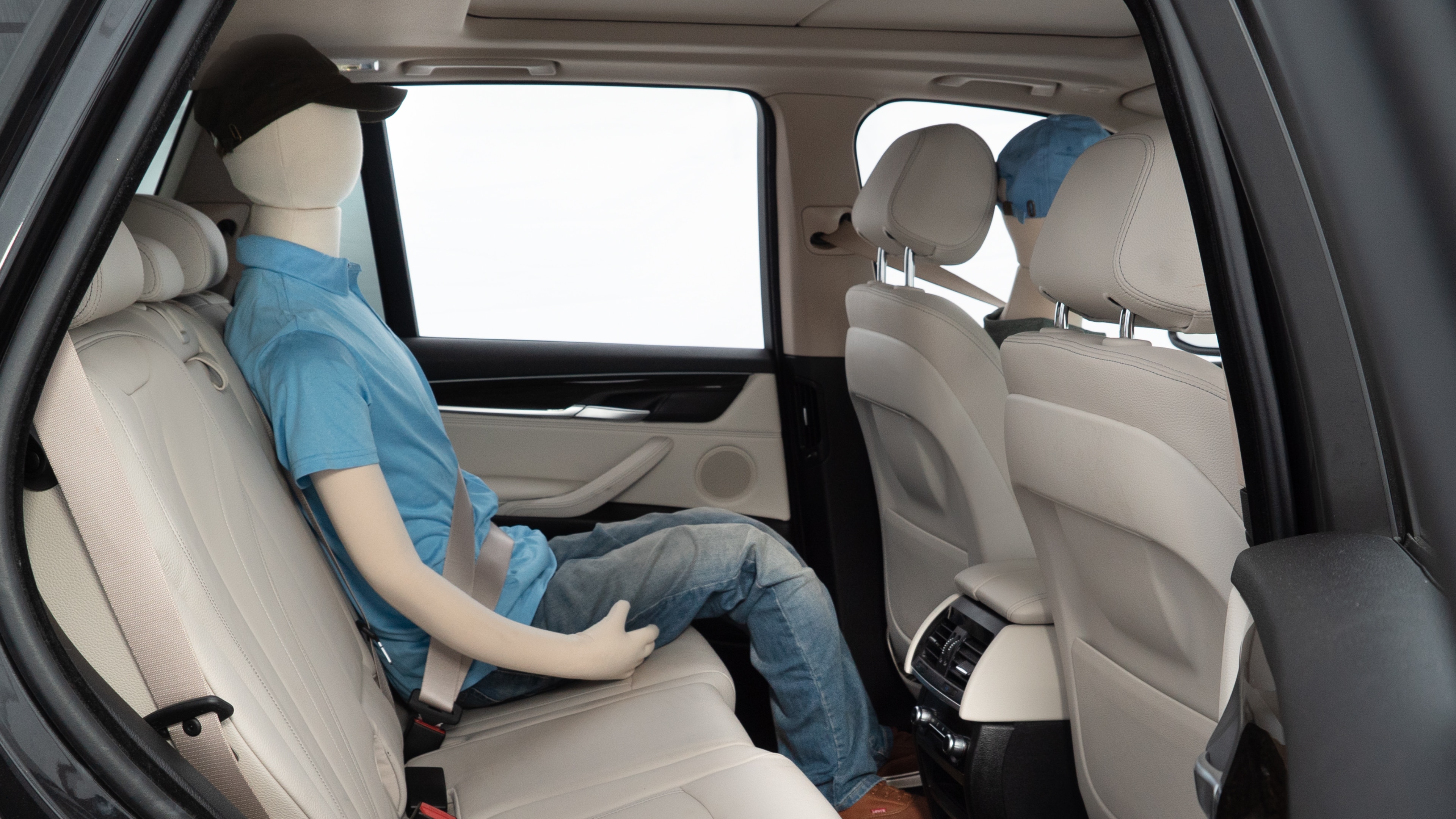 A series of second-row backseat photos is shown including one seating a baby seat and one seating a 6'1" mannequin.