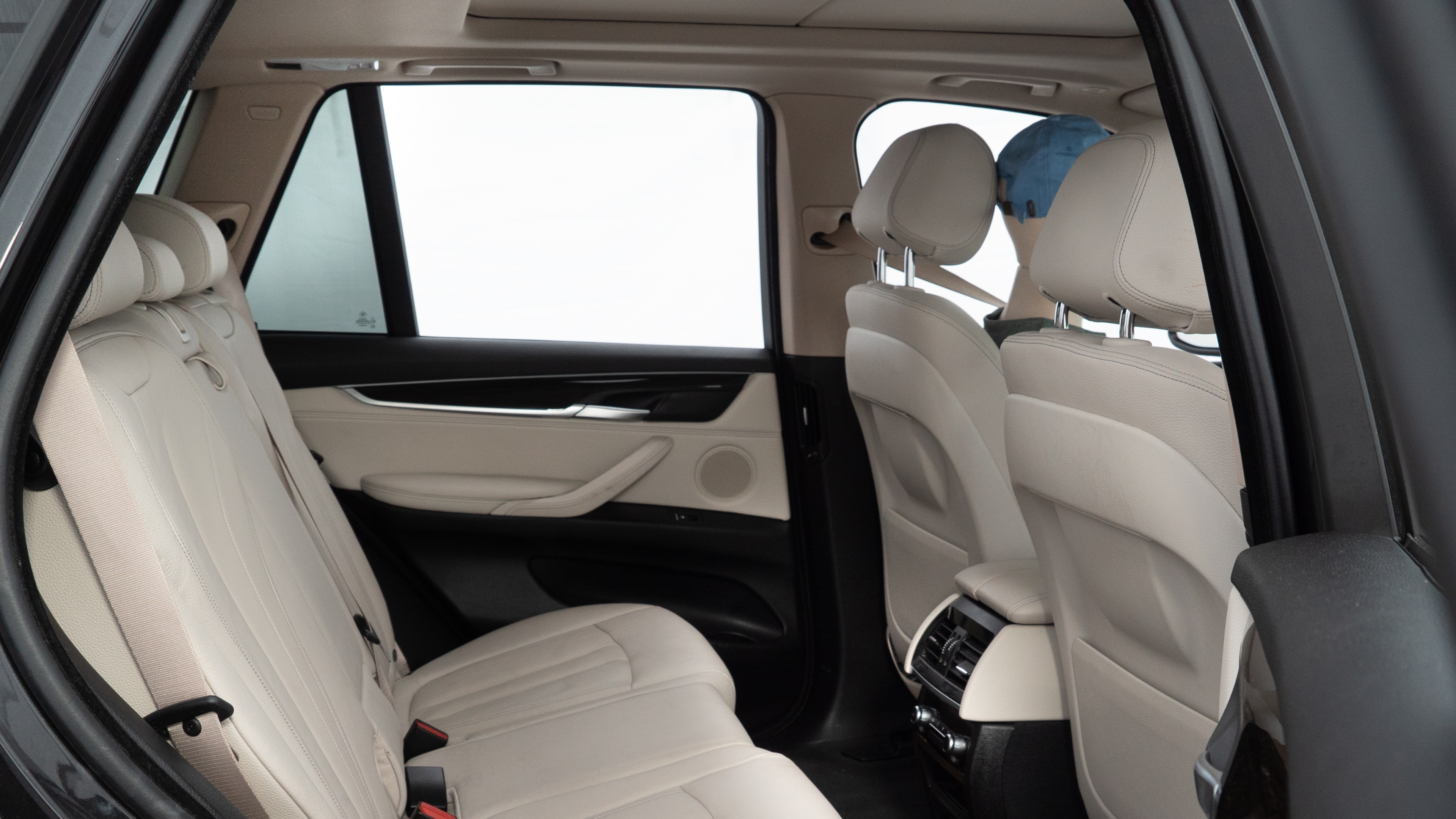 A series of second-row backseat photos is shown including one seating a baby seat and one seating a 6'1" mannequin.