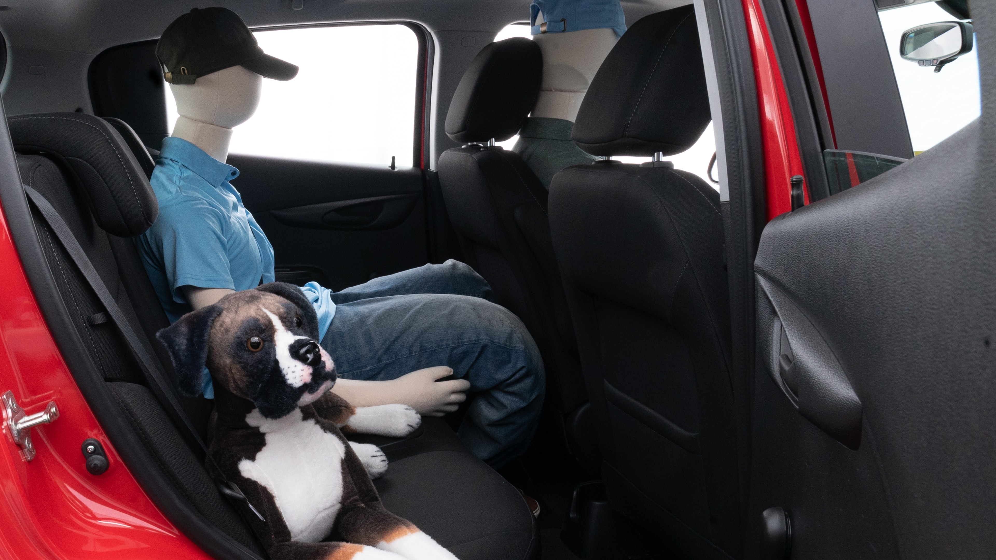 A series of second-row backseat photos is shown including one seating a baby seat and one seating a 6'1" mannequin.