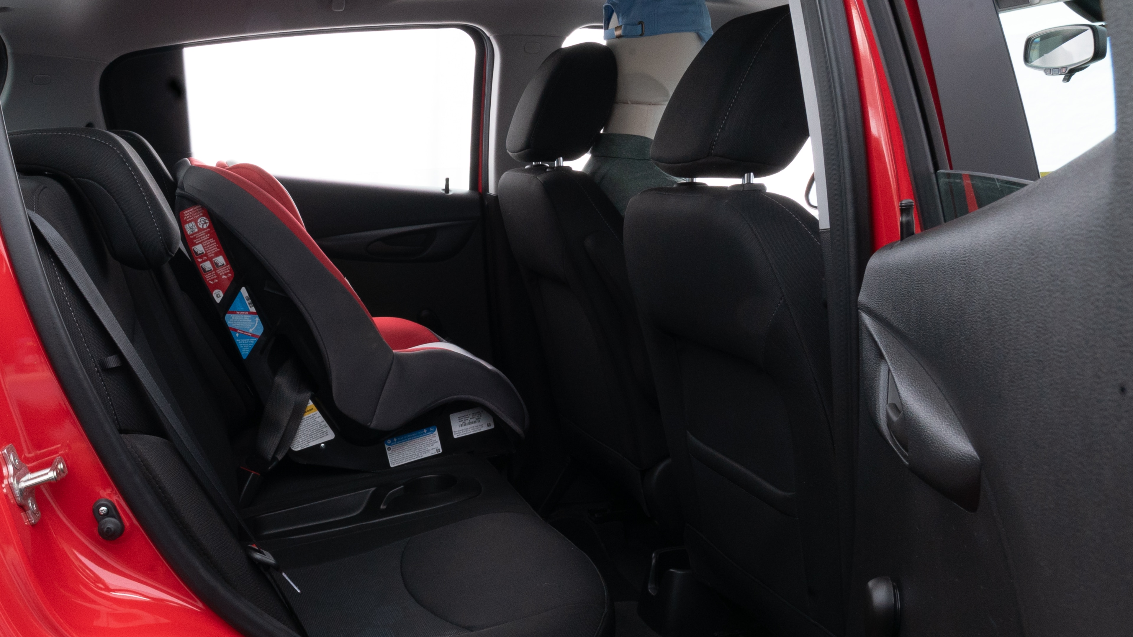 A series of second-row backseat photos is shown including one seating a baby seat and one seating a 6'1" mannequin.