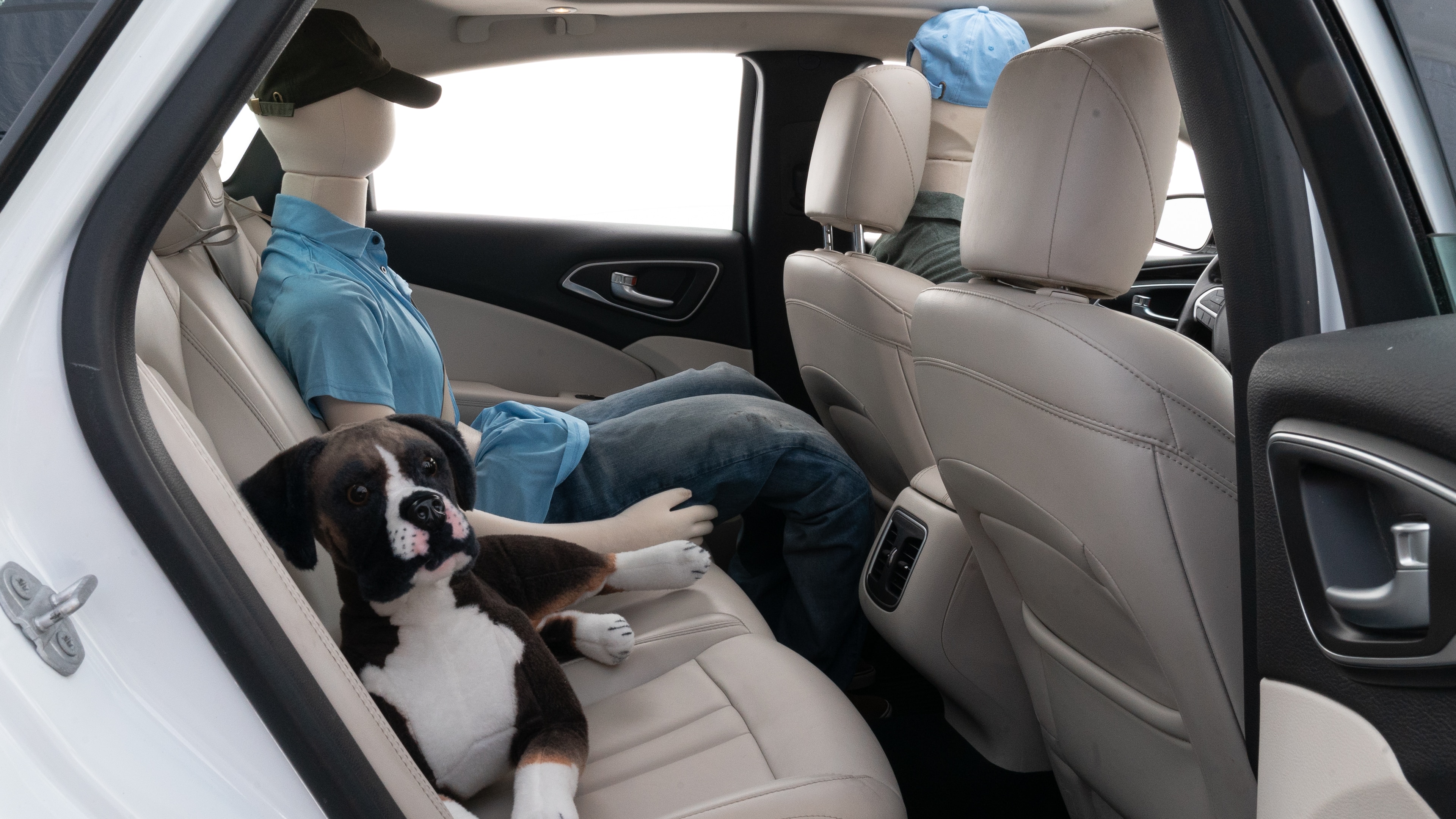 A series of second-row backseat photos is shown including one seating a baby seat and one seating a 6'1" mannequin.