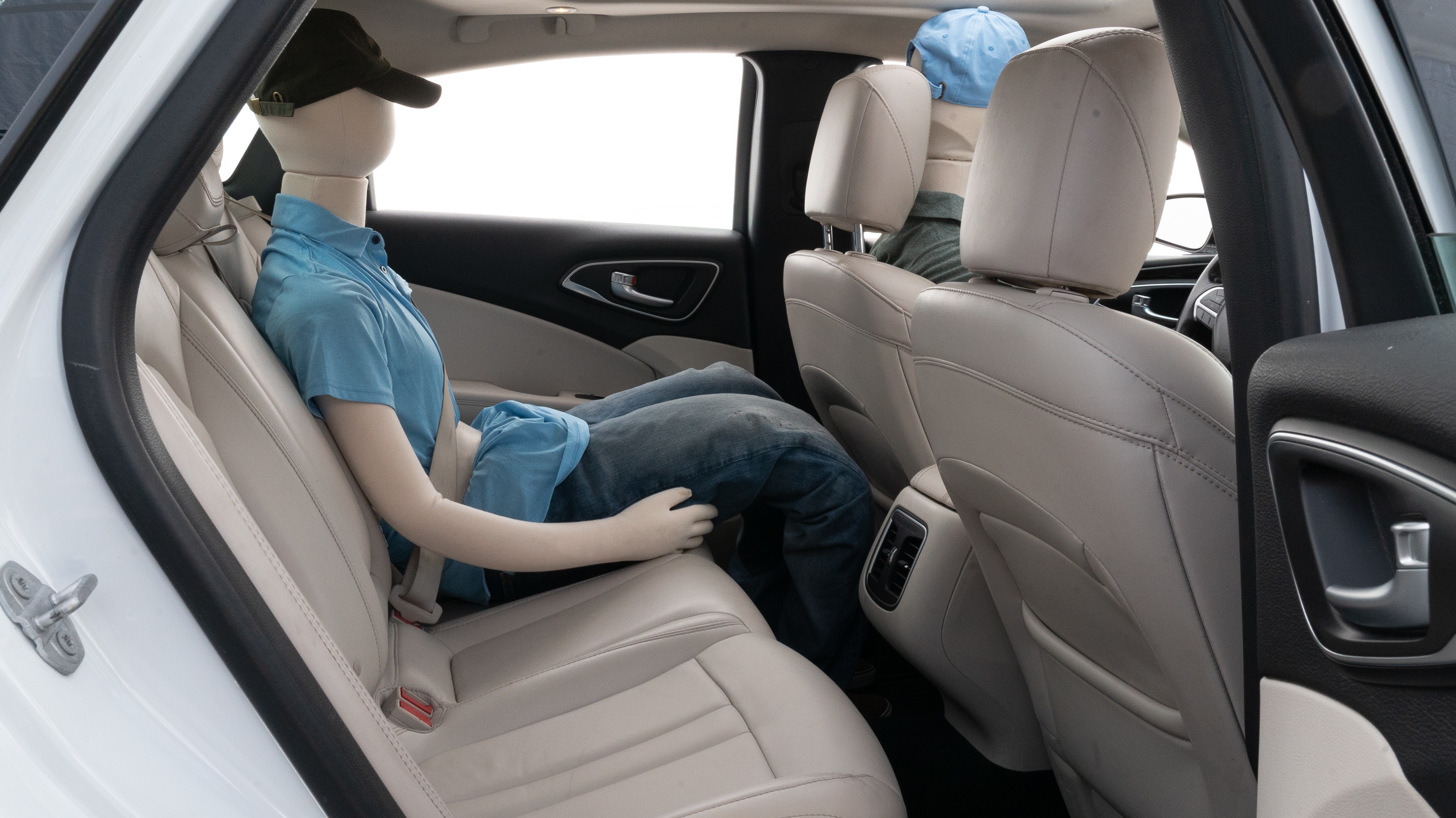 A series of second-row backseat photos is shown including one seating a baby seat and one seating a 6'1" mannequin.