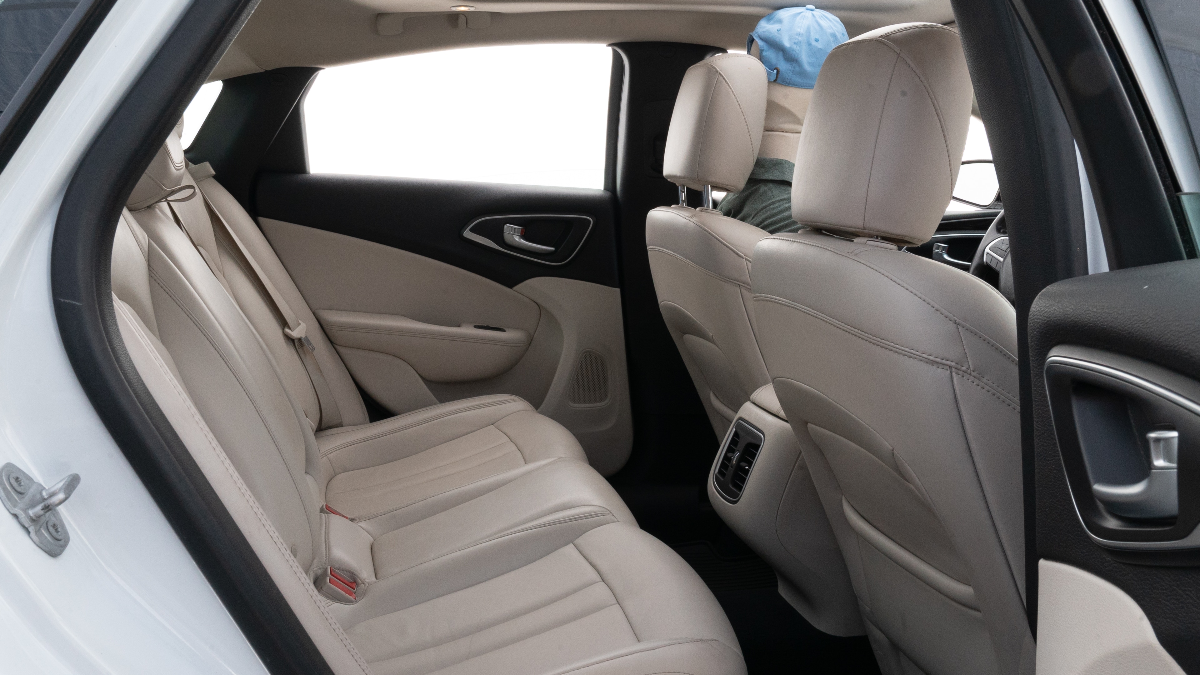 A series of second-row backseat photos is shown including one seating a baby seat and one seating a 6'1" mannequin.