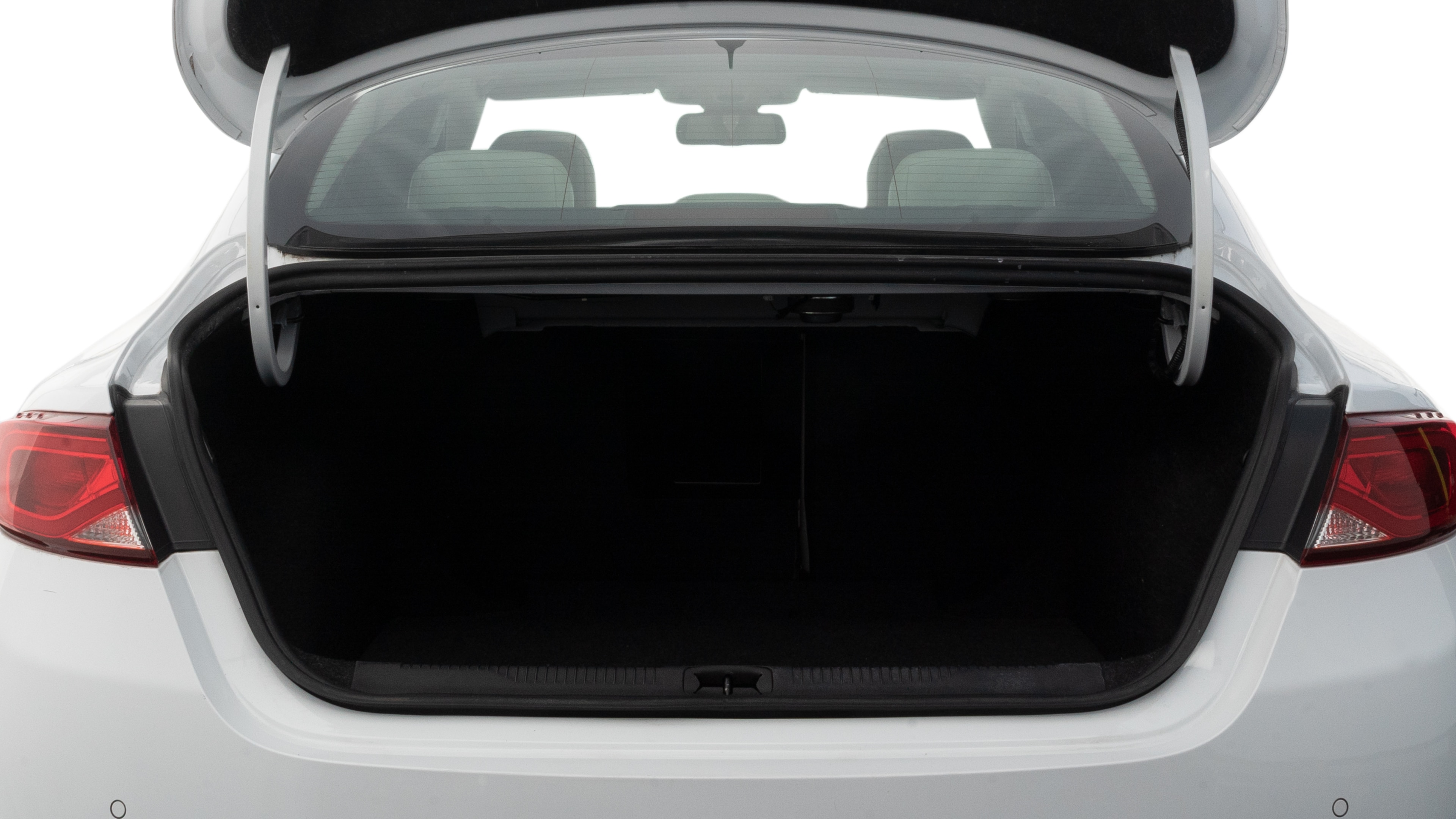 The trunk lid is open showing full view of the trunk. A baby stroller, three grocery carriers, two camping chairs in the carrying bag, and a set of golf clubs are placed inside.