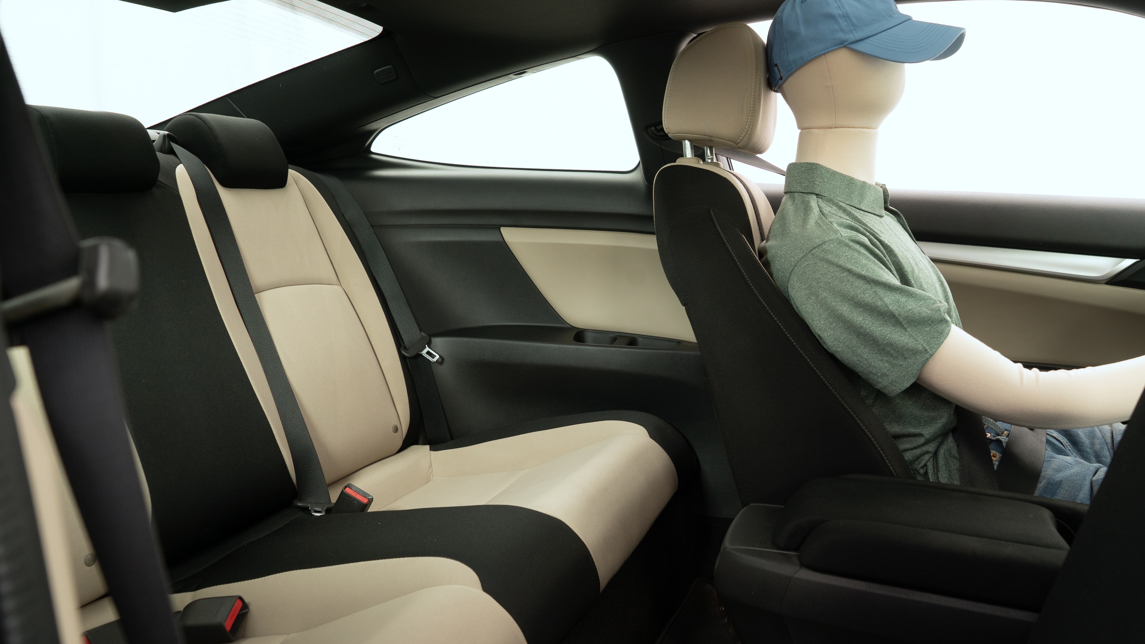 A series of second-row backseat photos is shown including one seating a baby seat and one seating a 6'1" mannequin.