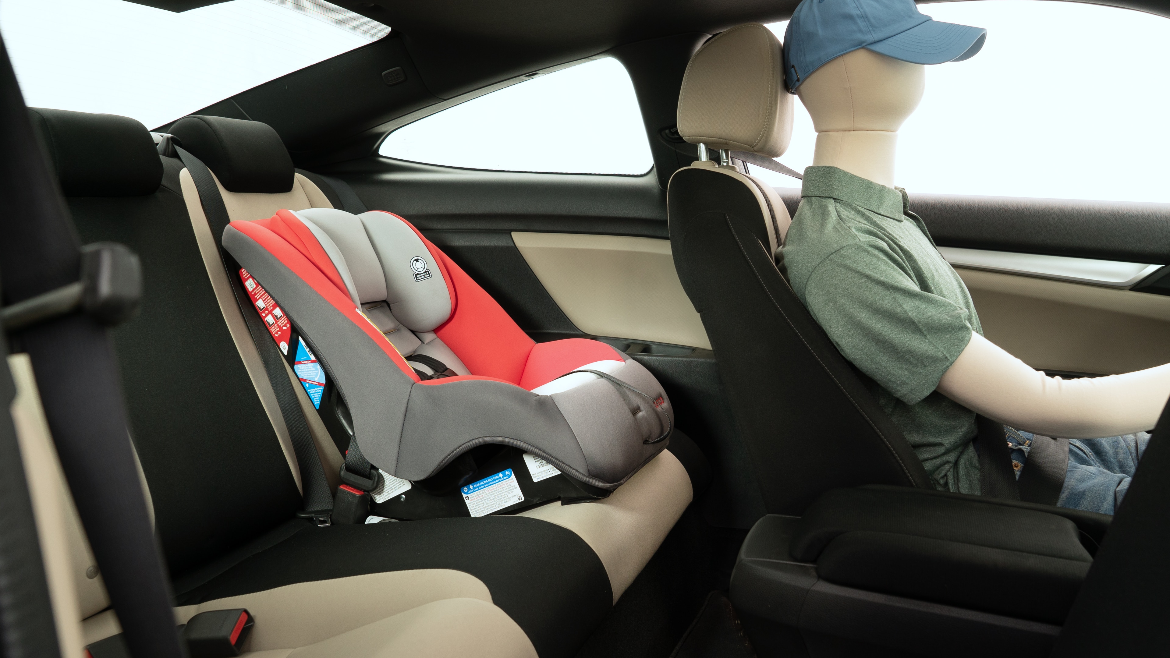 A series of second-row backseat photos is shown including one seating a baby seat and one seating a 6'1" mannequin.