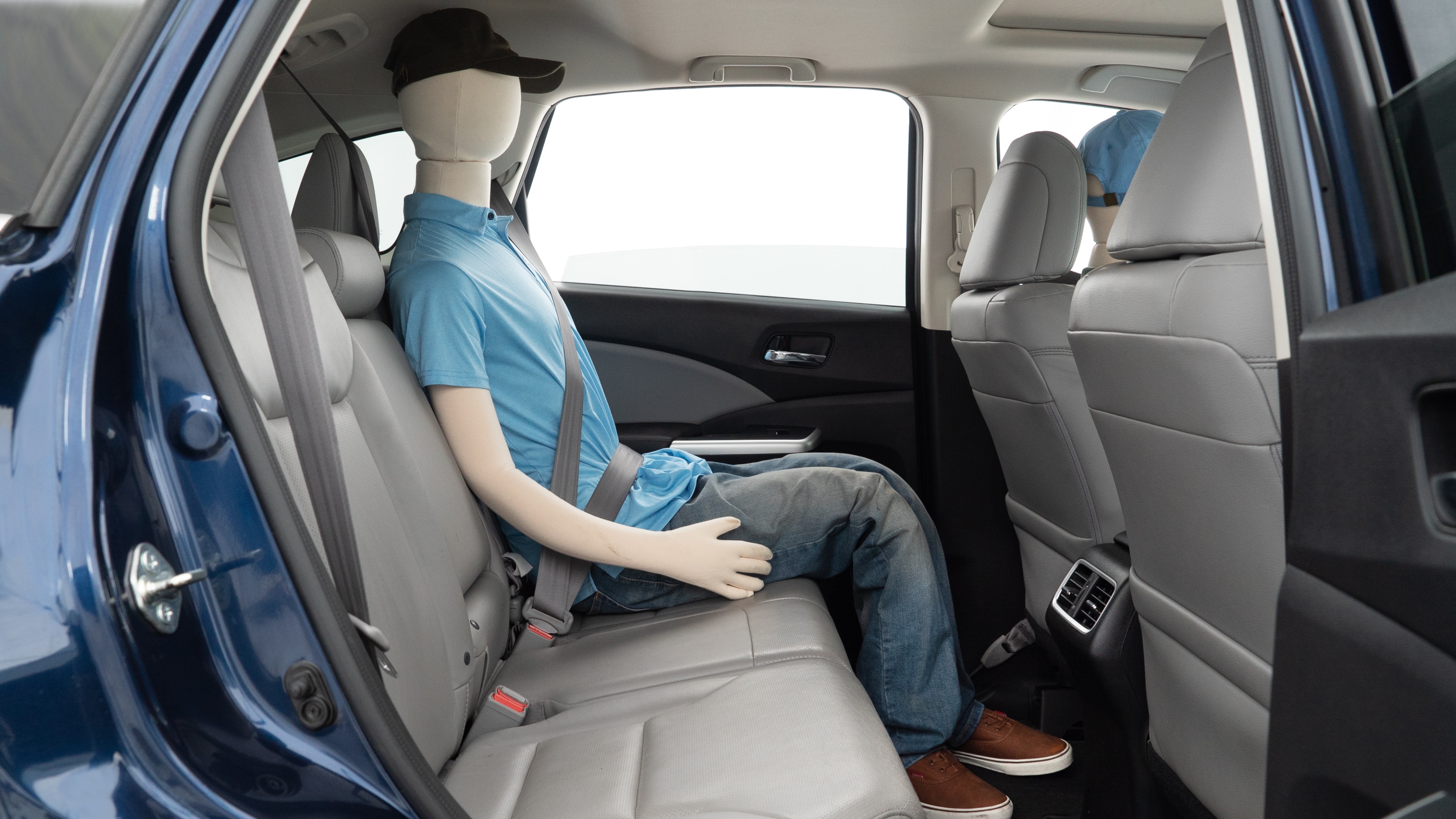 A series of second-row backseat photos is shown including one seating a baby seat and one seating a 6'1" mannequin.