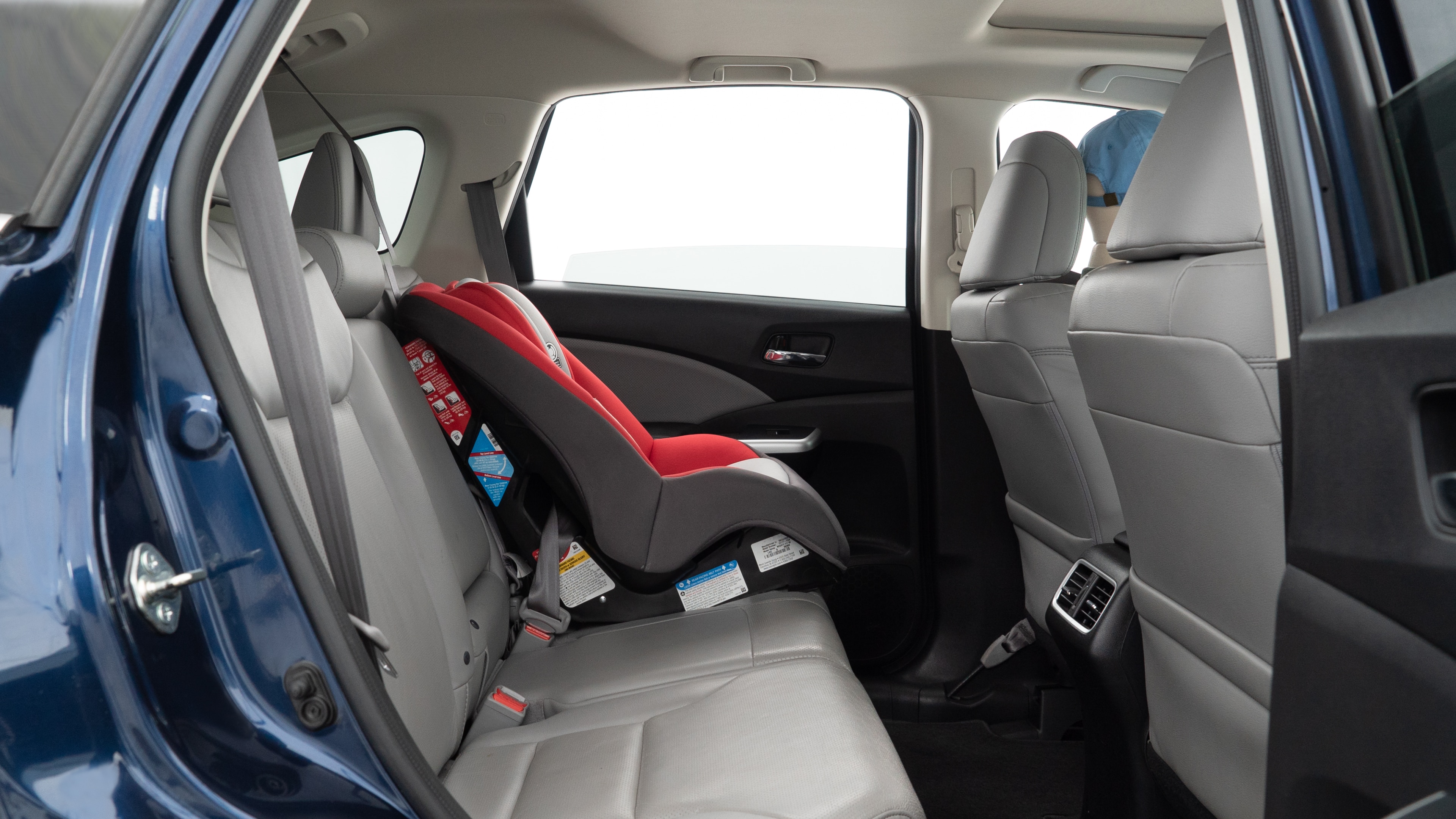 A series of second-row backseat photos is shown including one seating a baby seat and one seating a 6'1" mannequin.