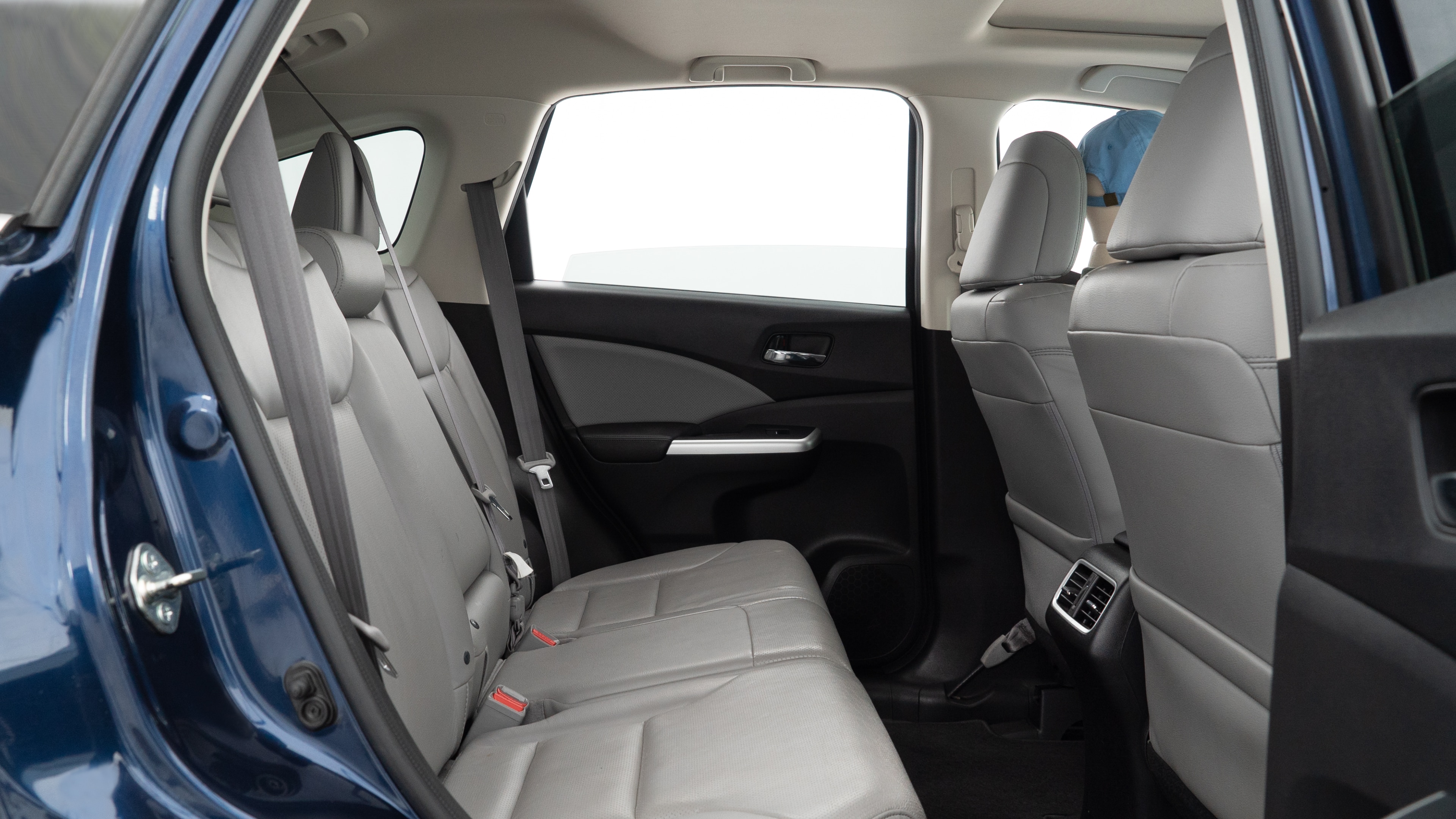 A series of second-row backseat photos is shown including one seating a baby seat and one seating a 6'1" mannequin.