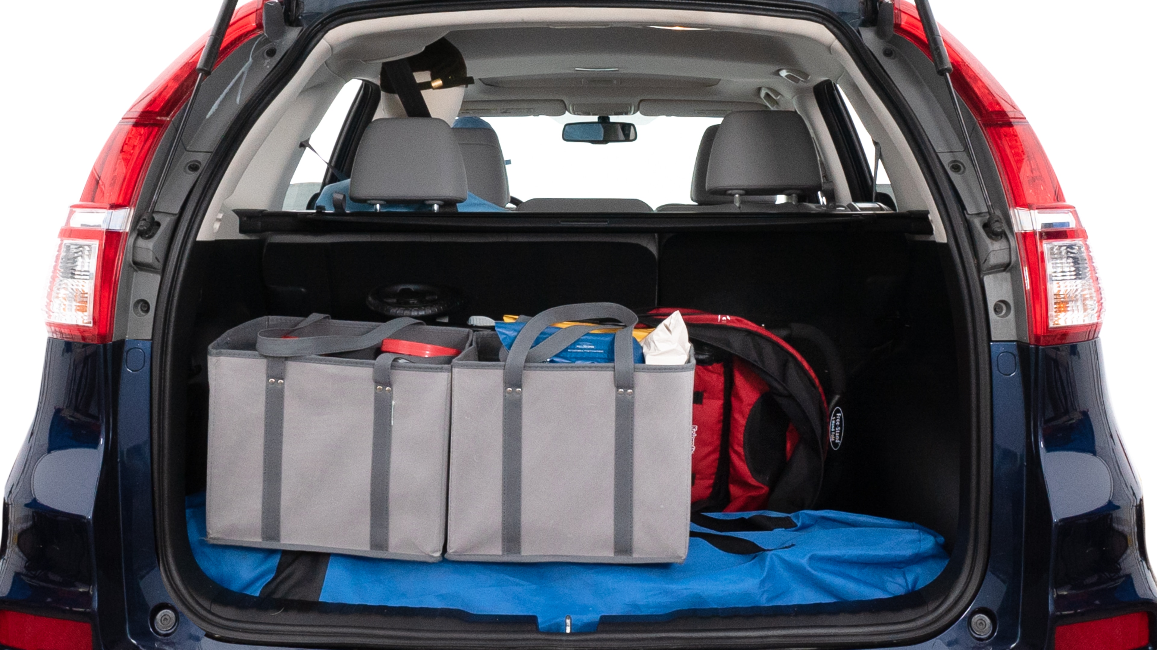 The trunk lid is open showing full view of the trunk. A baby stroller, three grocery carriers, two camping chairs in the carrying bag, and a set of golf clubs are placed inside.