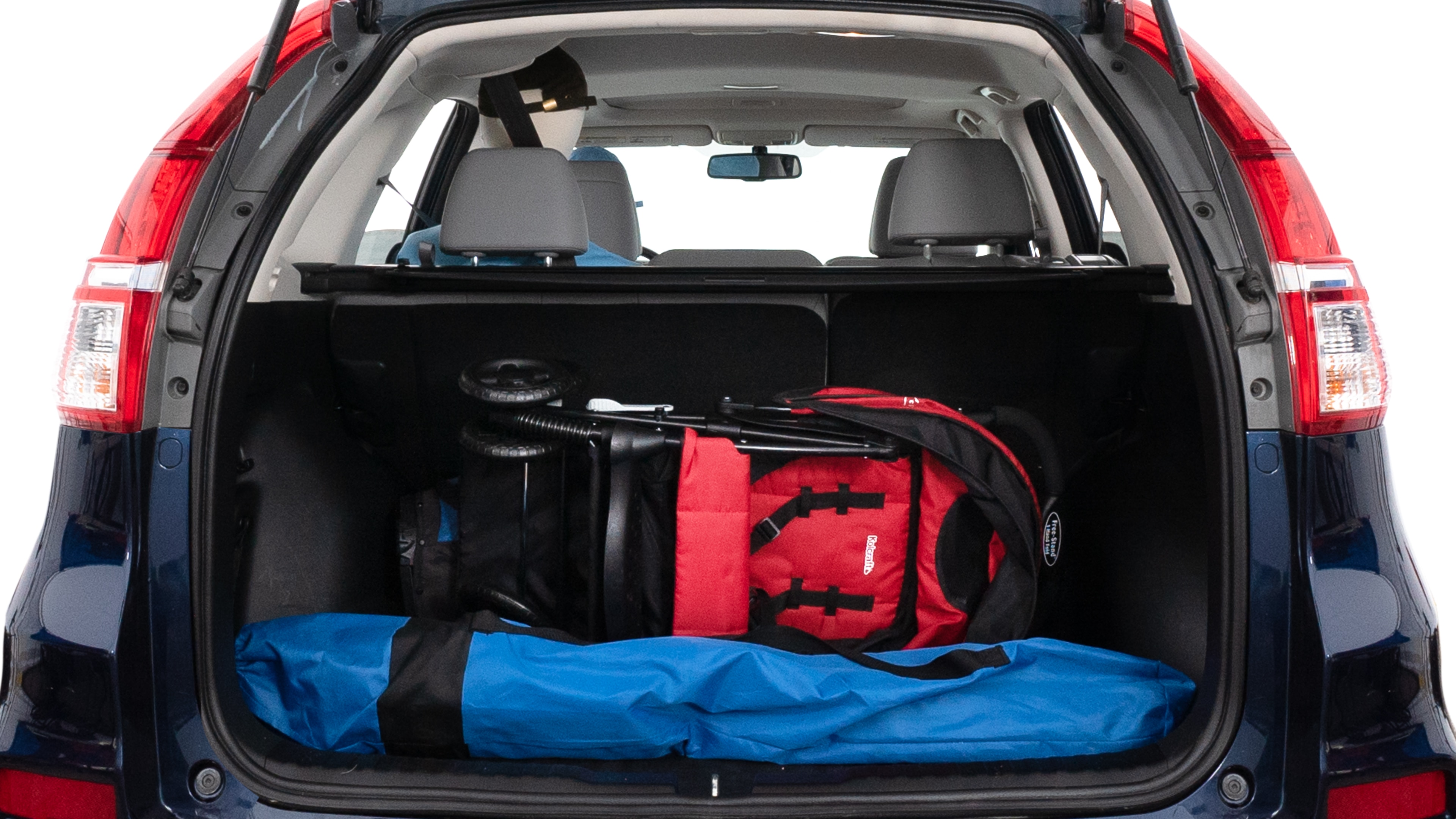 The trunk lid is open showing full view of the trunk. A baby stroller, three grocery carriers, two camping chairs in the carrying bag, and a set of golf clubs are placed inside.