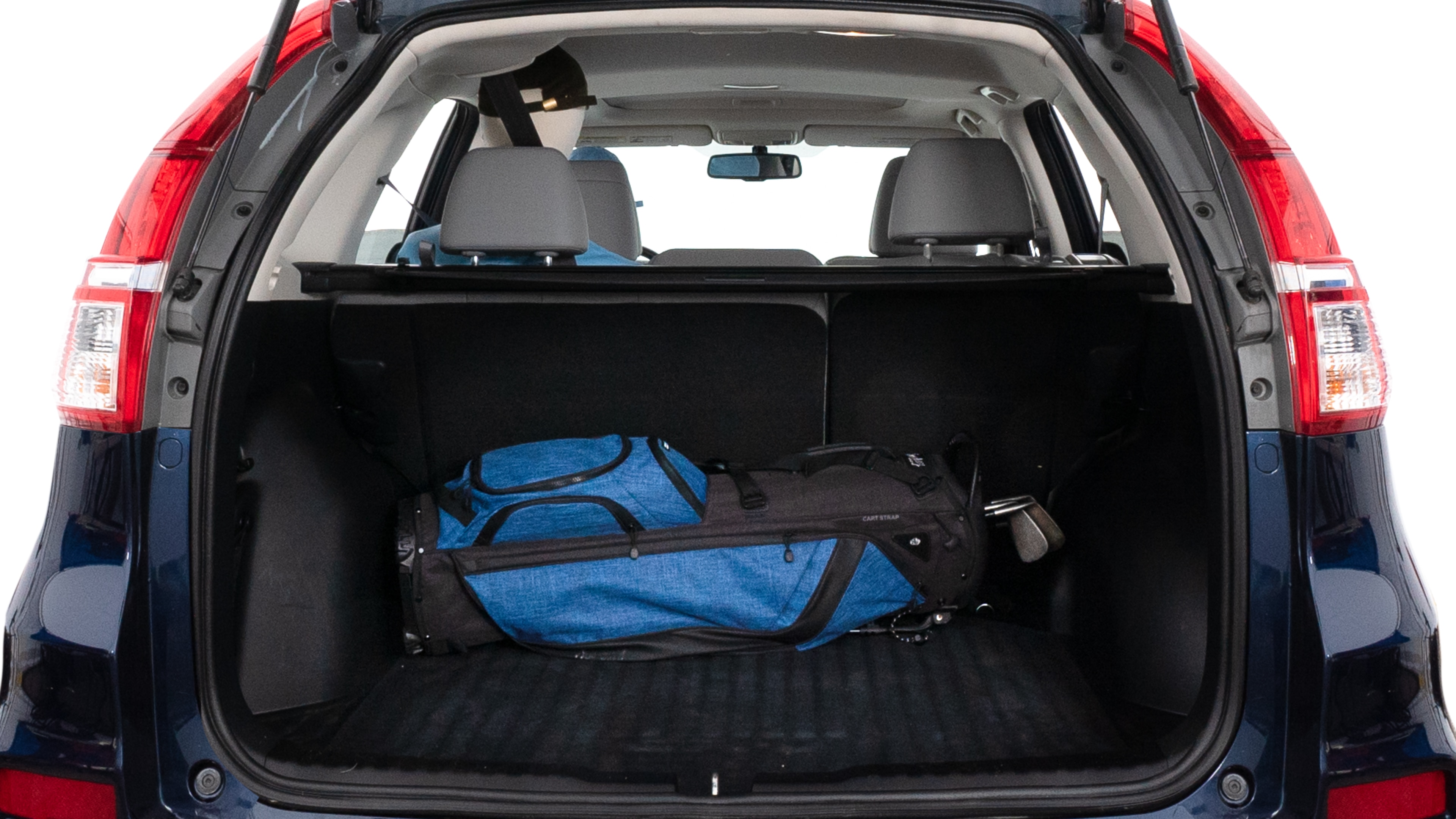 The trunk lid is open showing full view of the trunk. A baby stroller, three grocery carriers, two camping chairs in the carrying bag, and a set of golf clubs are placed inside.