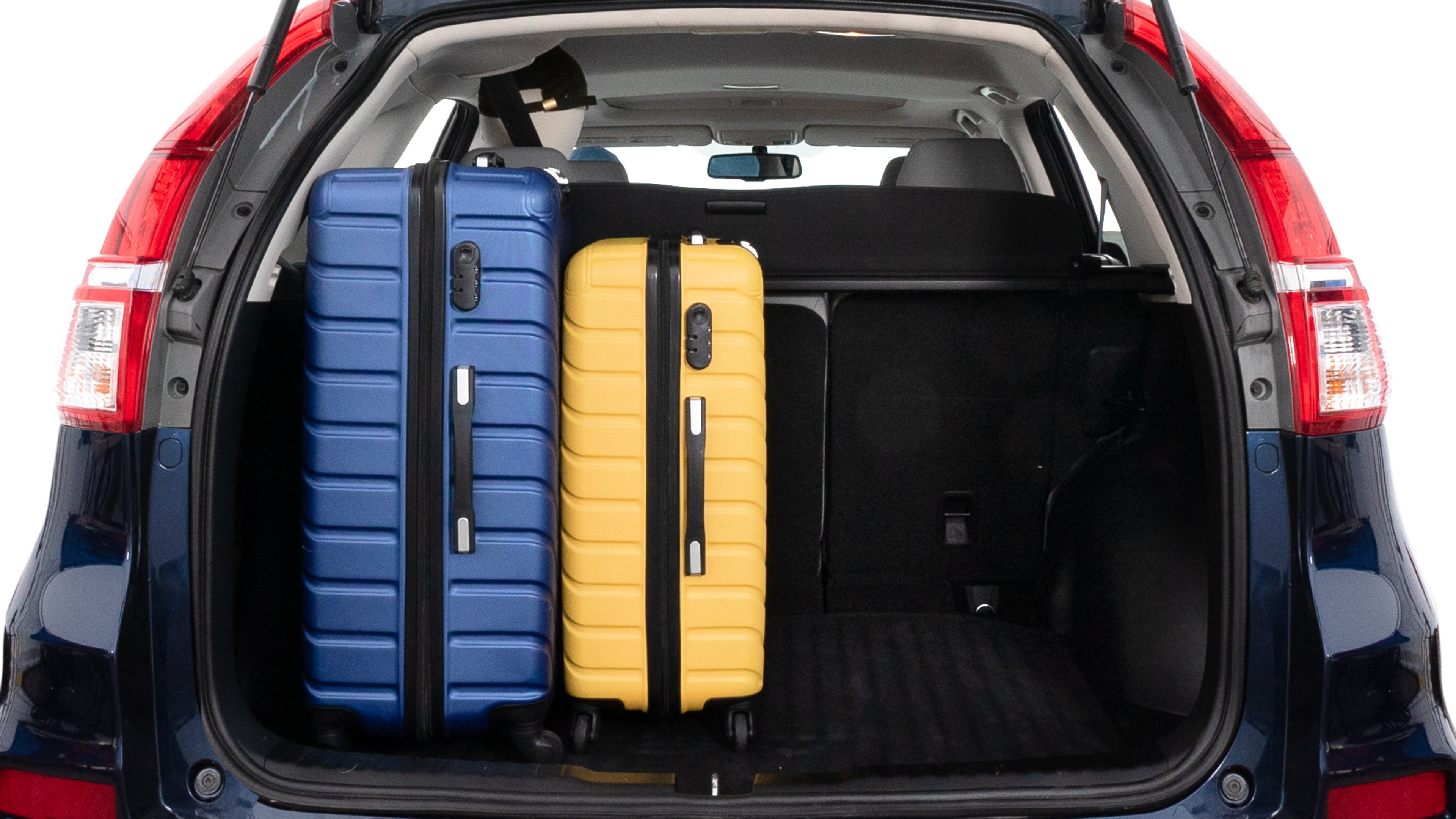 The trunk lid is open, showing full view of the trunk space. One large, two medium and two small suitcases are placed inside.